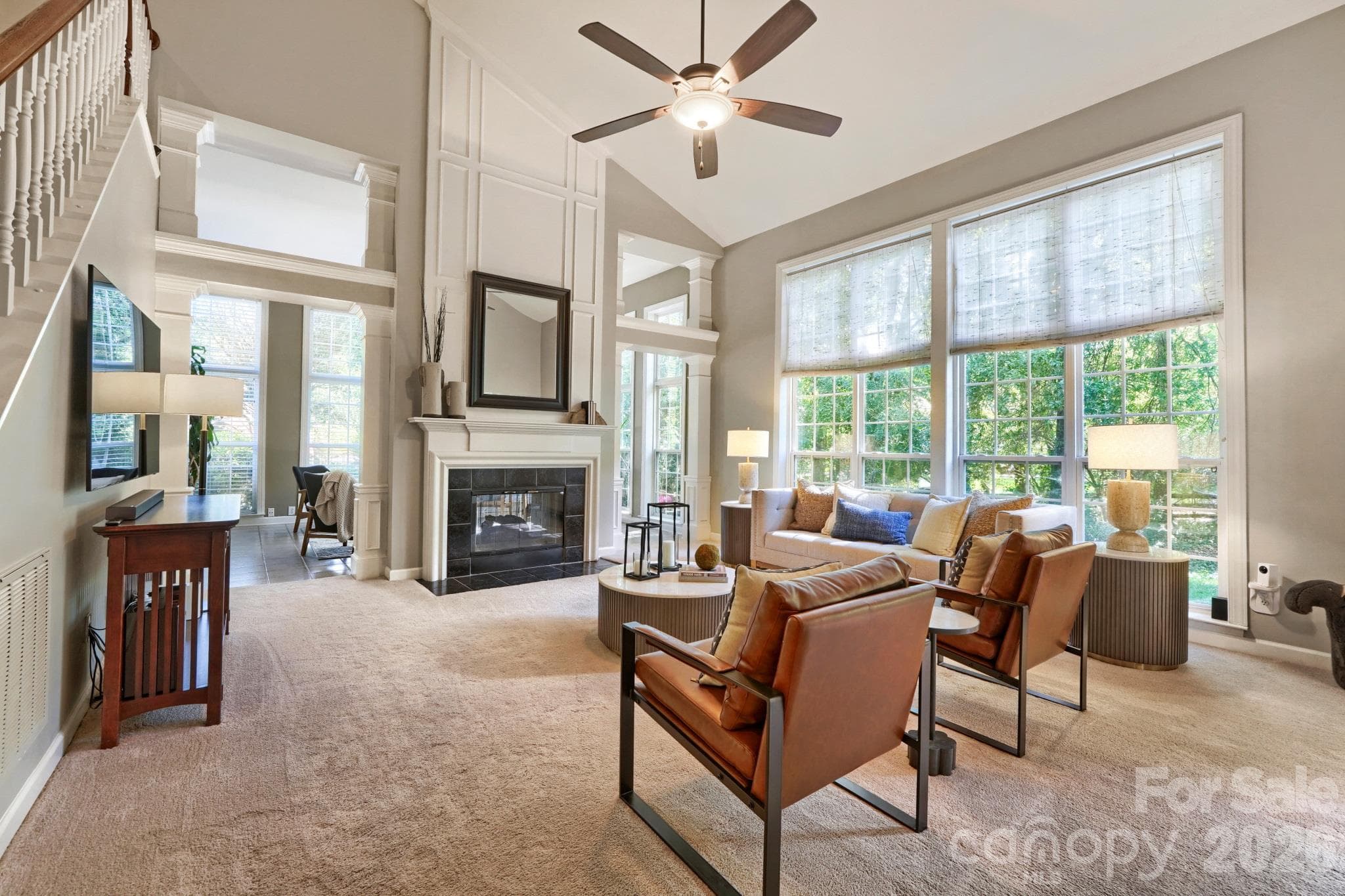 Two story light filled living room with two sided gas fireplace - 10808 Pomerane Place, Charlotte