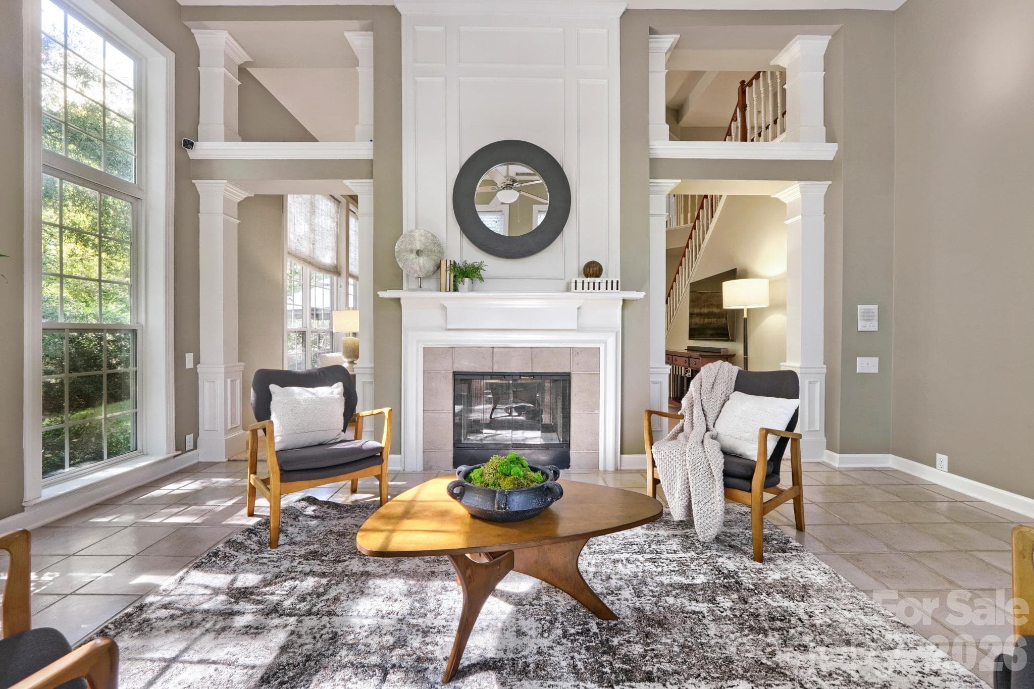 Two story light filled sunroom with two sided gas fireplace - 10808 Pomerane Place, Charlotte