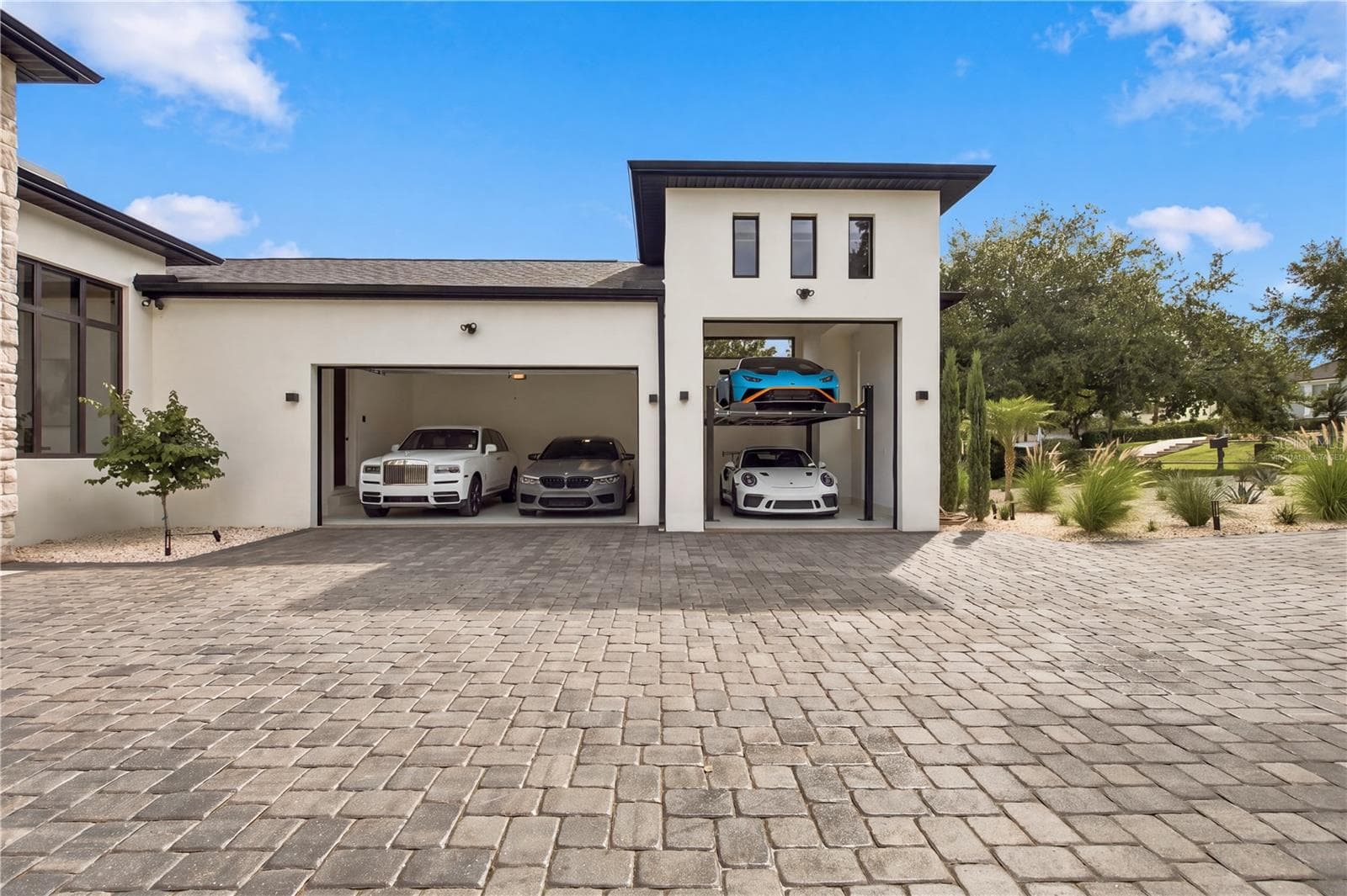 cars and lift are virtually staged to show size of garage. - 11500 OSPREY POINTE BLVD, CLERMONT