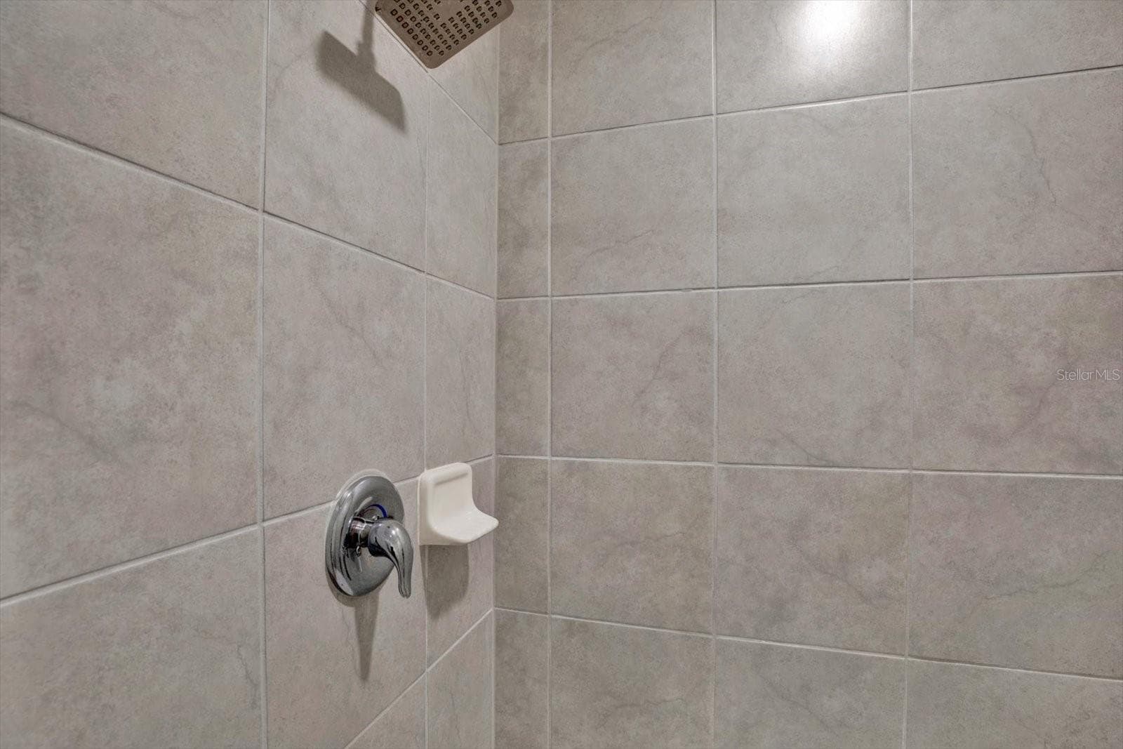 Tiled shower in the primary bath - 8538 REEDVILLE ST, NEW PORT RICHEY