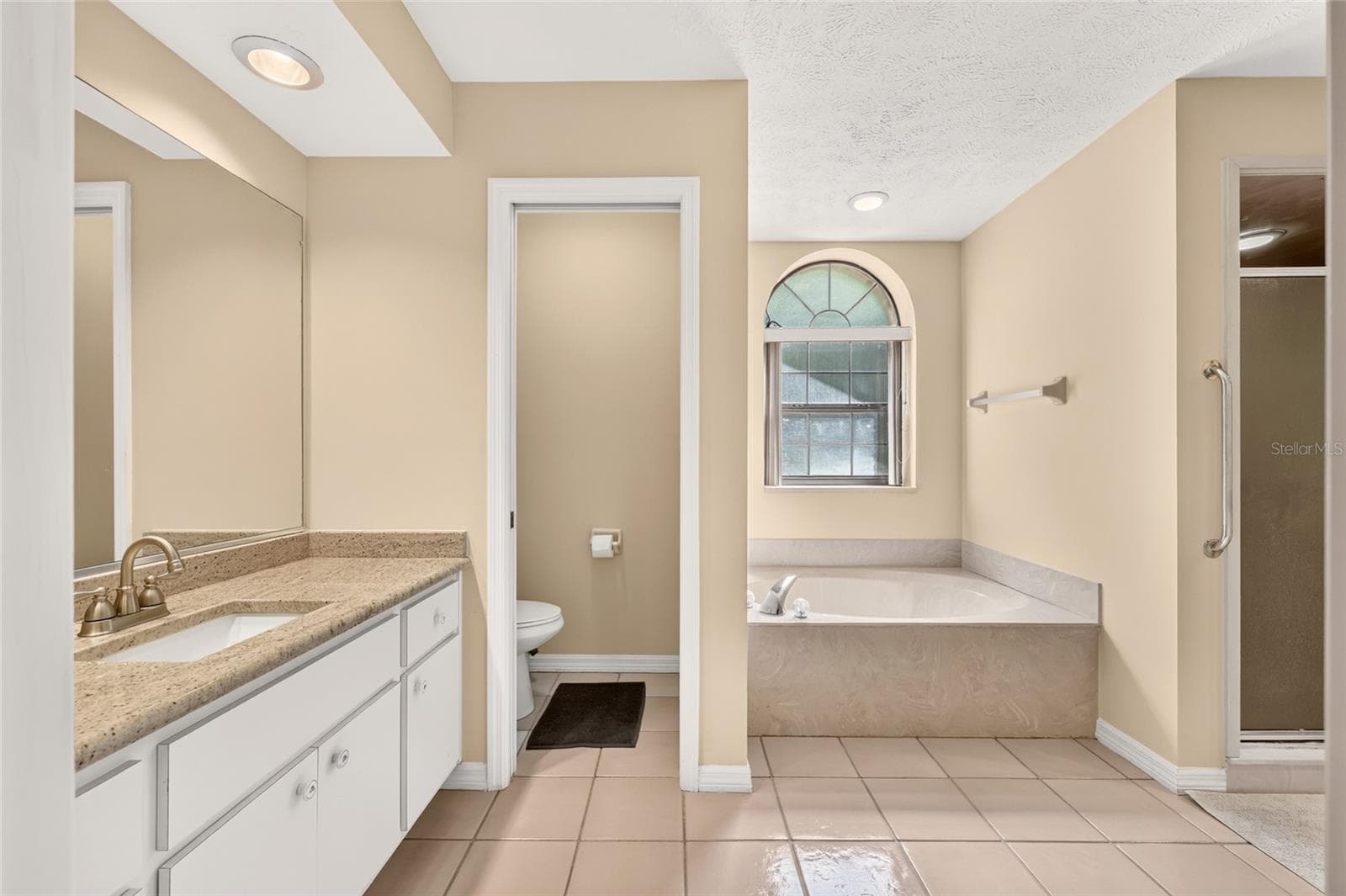 Primary Bathroom with two vanities with granite countertops. - 3450 SW 52ND TER, OCALA