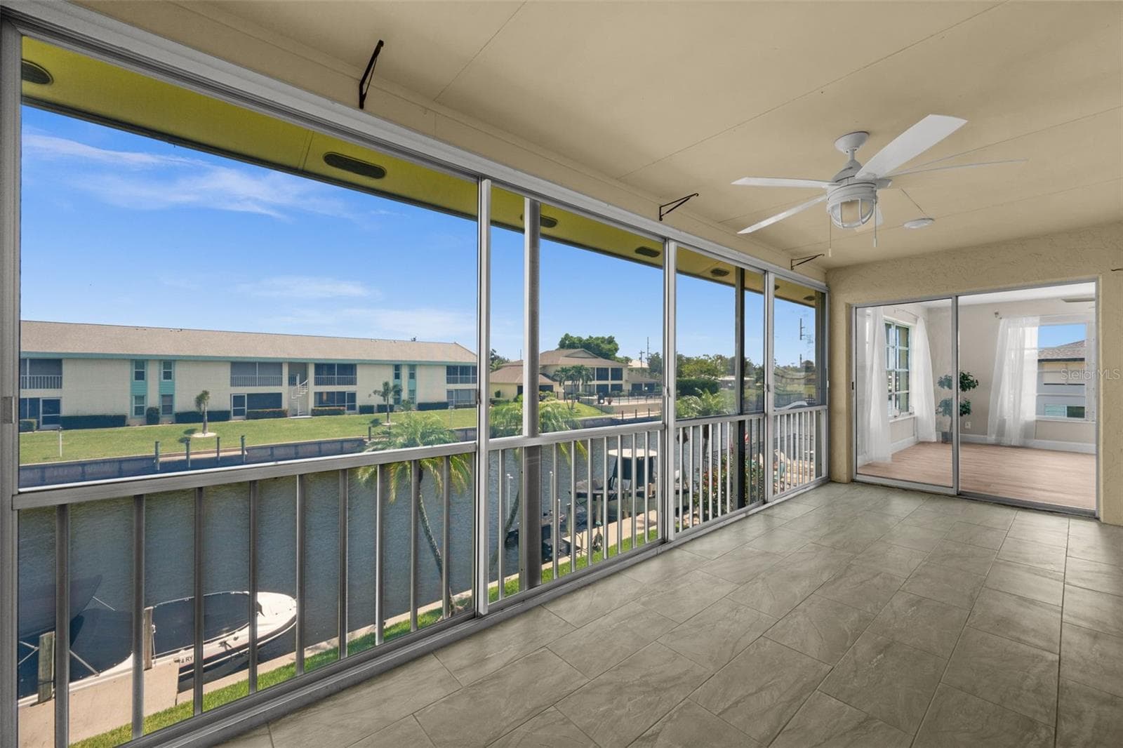 Lanai overlooking the canal with patio doors. - 1345 SE 40TH TER #2E, CAPE CORAL