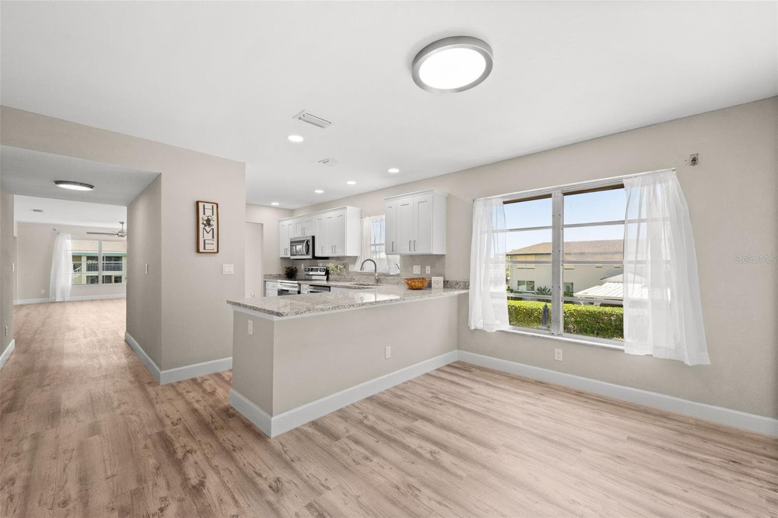 Looking from the breakfast nook to kitchen and living - 1345 SE 40TH TER #2E, CAPE CORAL