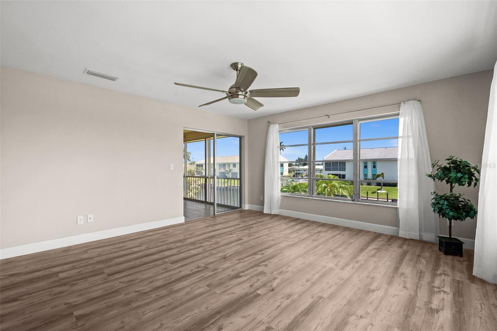 Living Room overlooks the canal and has access to the lanai - 1345 SE 40TH TER #2E, CAPE CORAL