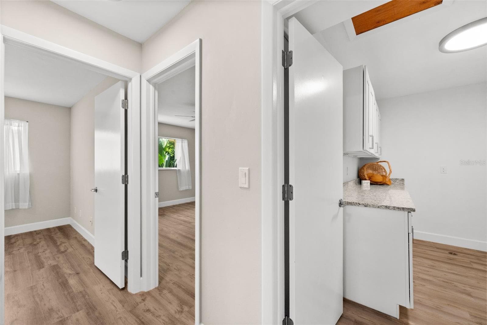 Hallway with access to laundry room and bedroom 2 and bedroom 3 - 1345 SE 40TH TER #2E, CAPE CORAL