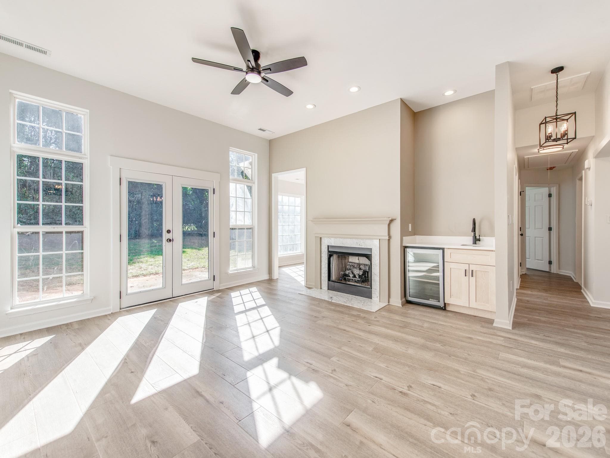 Family room offers gas log fireplace, wine bar and patio doors. - 810 Greenhill Drive, Charlotte