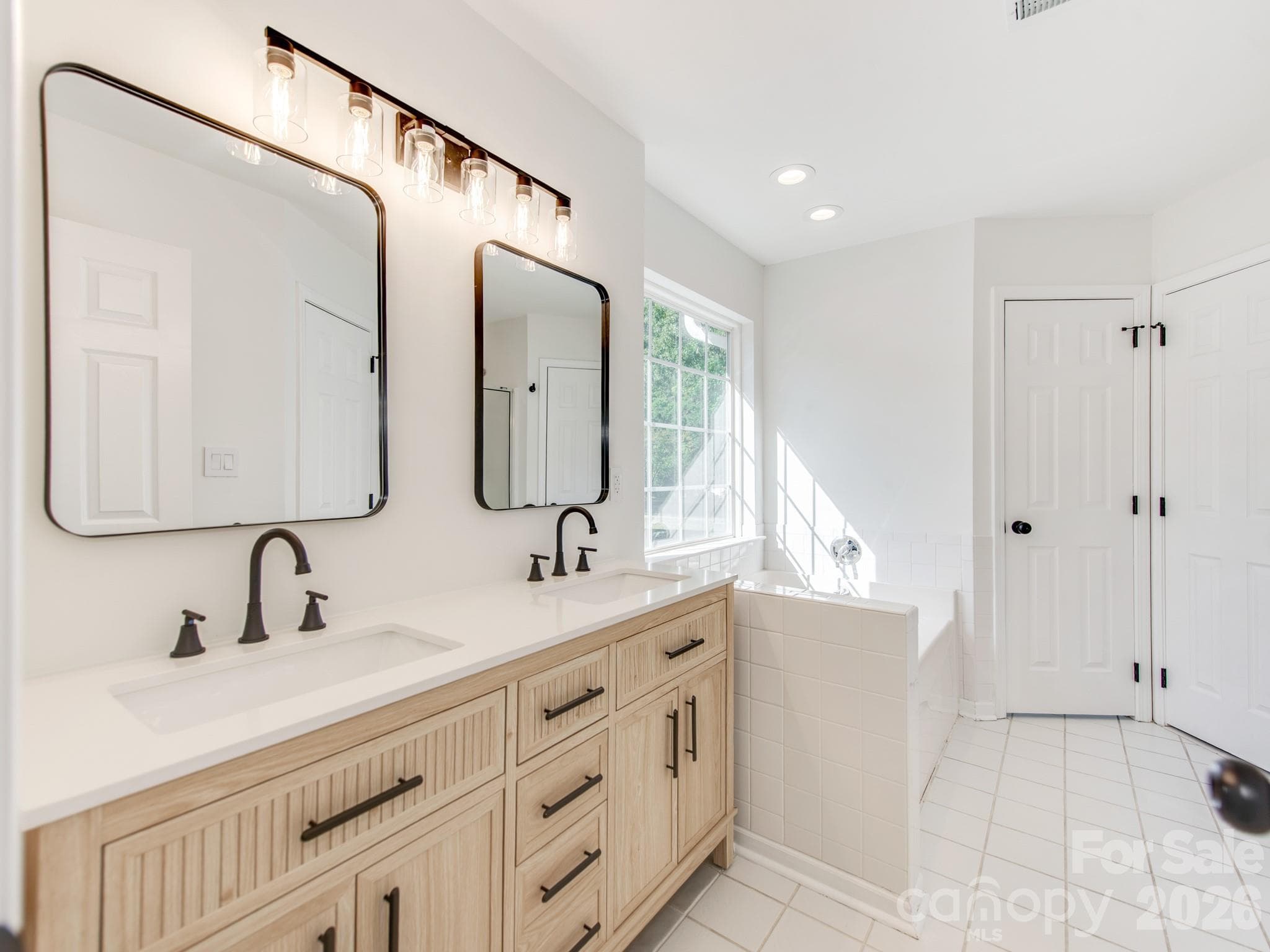 Primary bathroom, New vanity, Mirrors, Light fixtures and hardware. - 810 Greenhill Drive, Charlotte