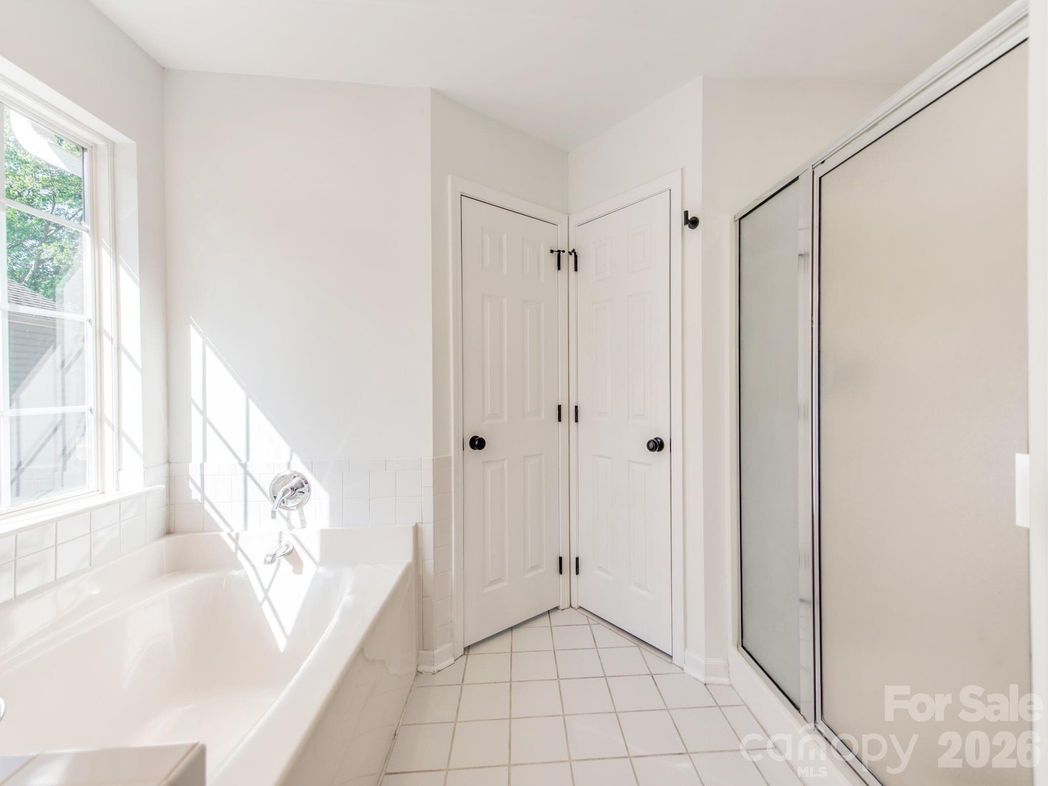 Primary bathroom with soaking tub and separate walk-in shower - 810 Greenhill Drive, Charlotte