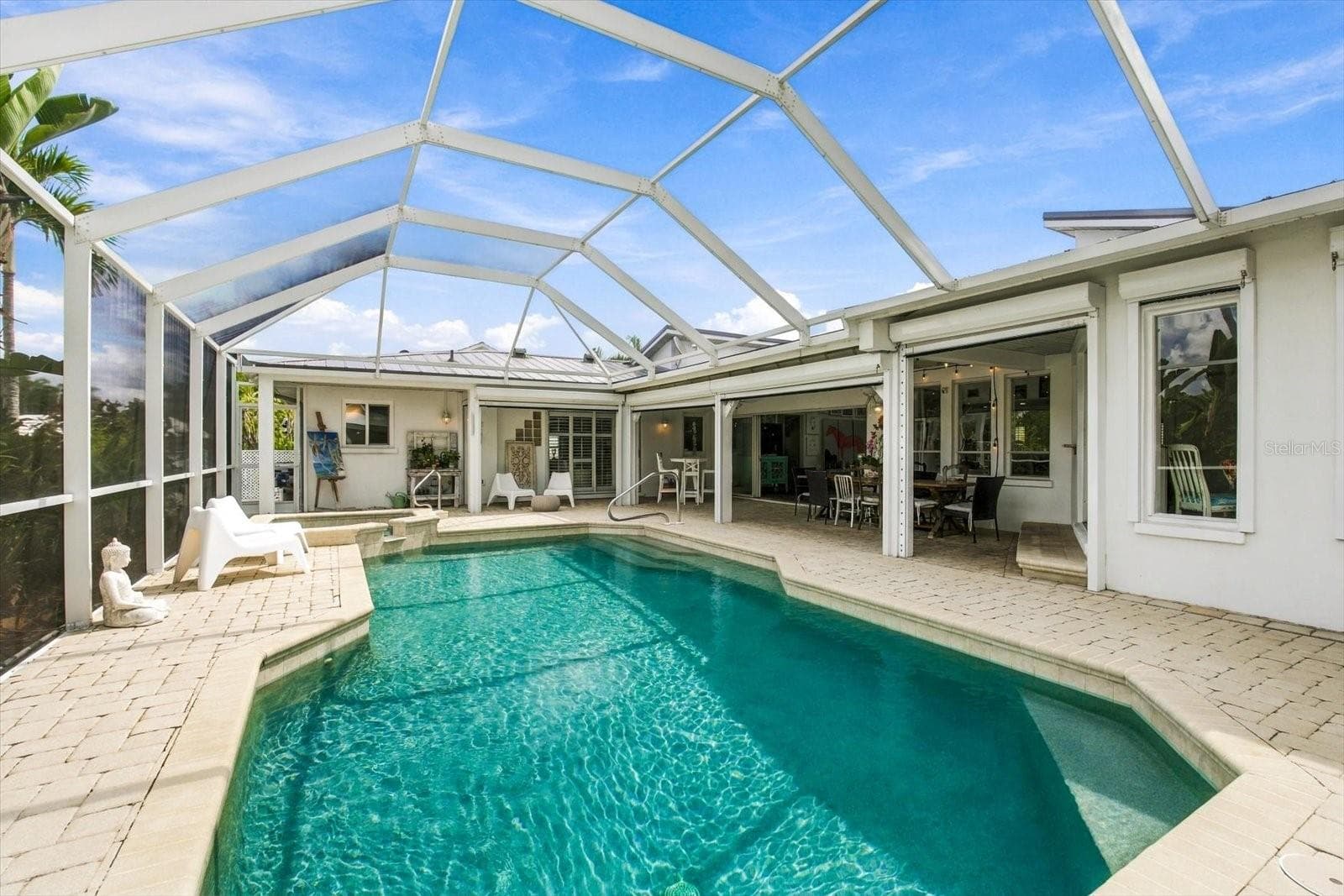 Automatic roll down hurricane shutters protect the covered pool area. - 1741 STANFORD LN, SARASOTA