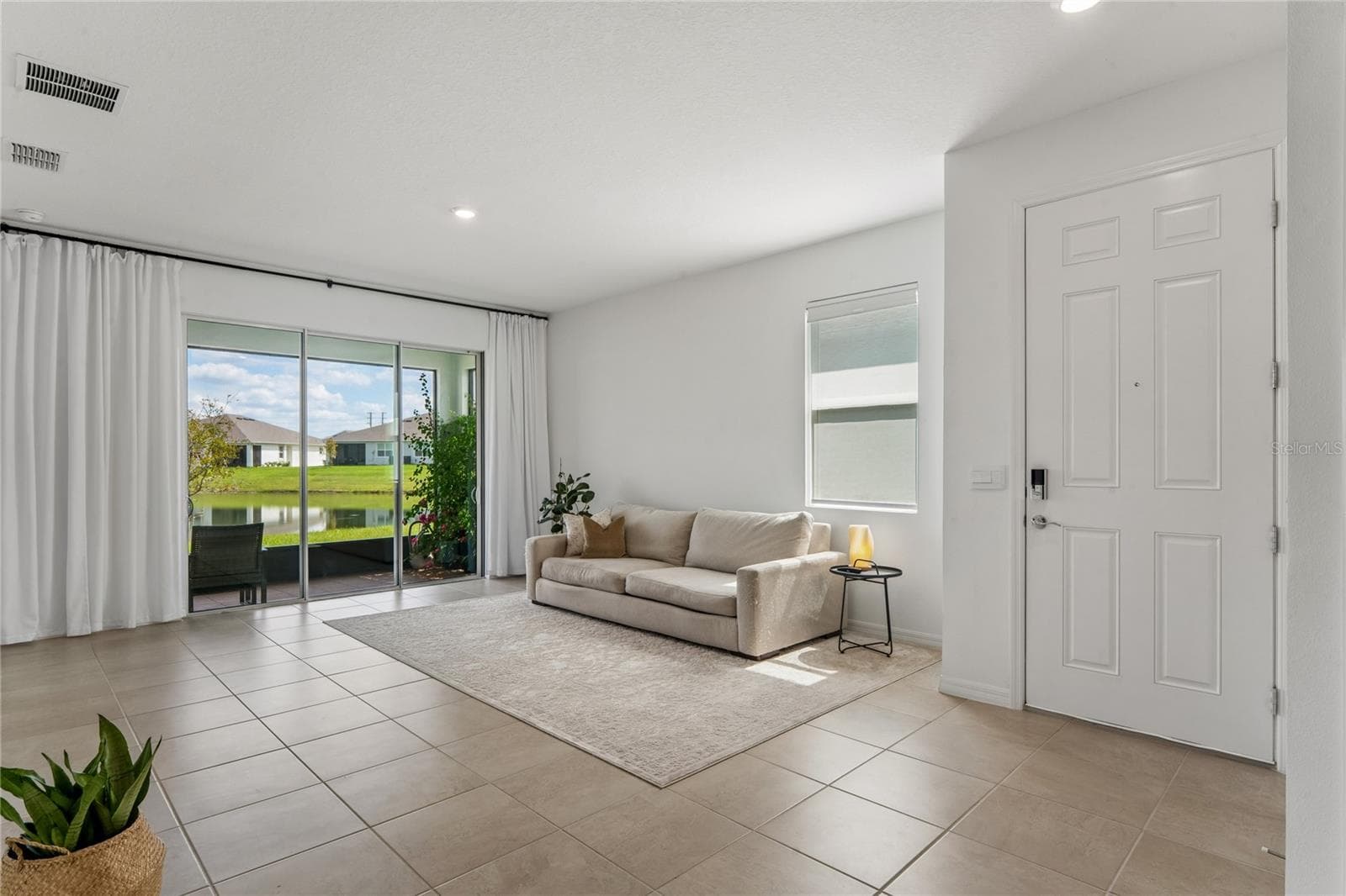 Living room view from kitchen - 8580 BOLD CYPRESS LN, WESLEY CHAPEL