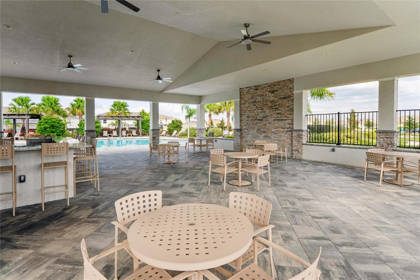 Seating for gathering at the pool lanai - 8580 BOLD CYPRESS LN, WESLEY CHAPEL
