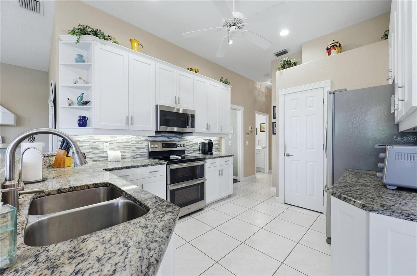 Kitchen features stainless appliances, granite and tiled backsplash - 3200 BAY RIDGE WAY, PORT CHARLOTTE