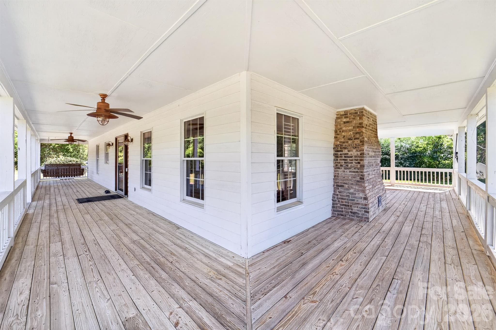 Porch wraps arounds 3 sides of the home - 9702 Quail Cove Court, Indian Trail