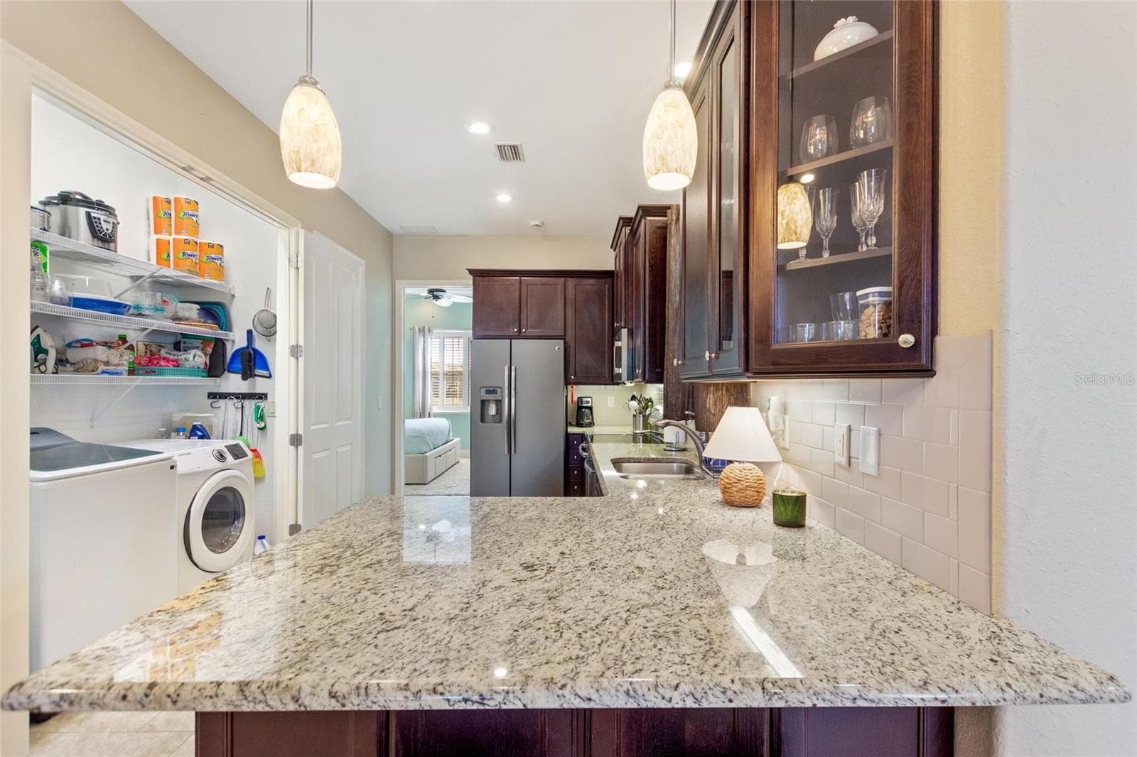 Kitchen with doors open to the laundry closet - 1030 CROSS ROADS DR, POLK CITY
