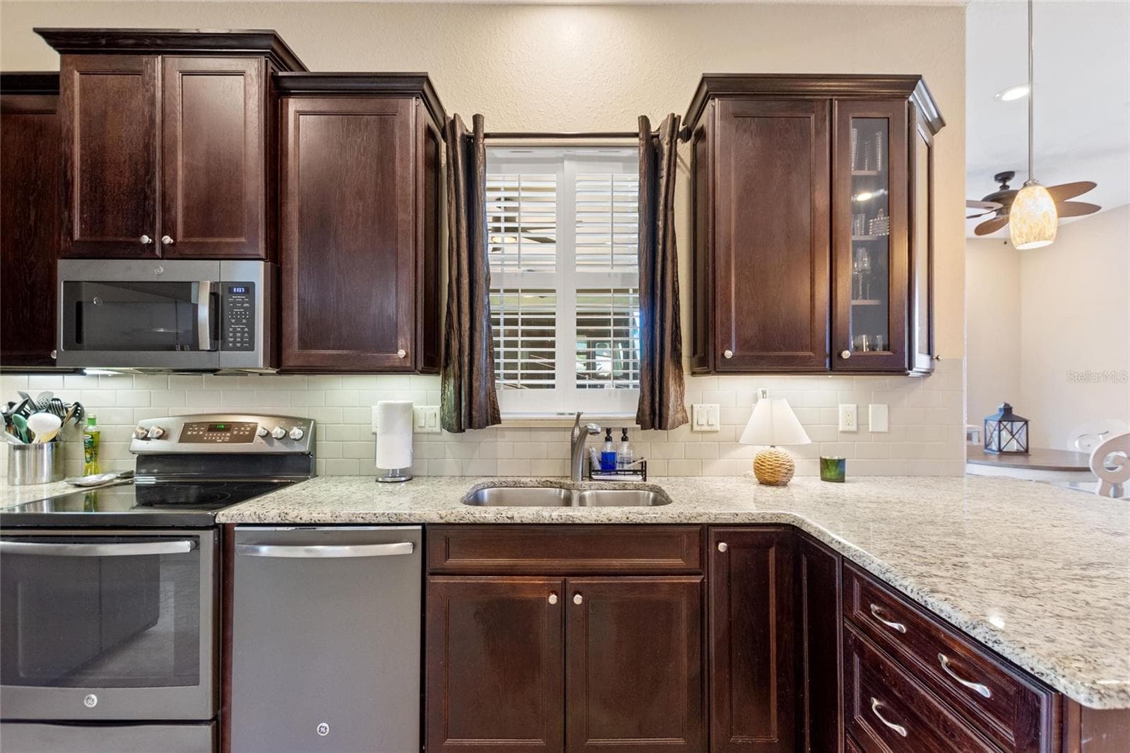 Kitchen with window looking onto the RV port - 1030 CROSS ROADS DR, POLK CITY