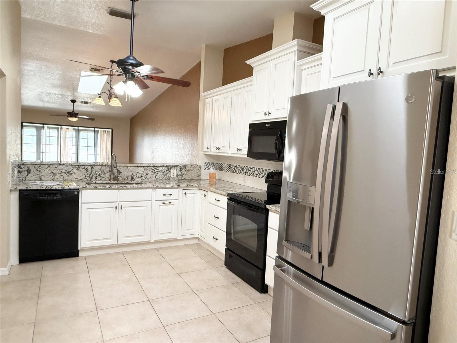 Kitchen opens to dining / living room - 1640 ATARES DR #16, PUNTA GORDA