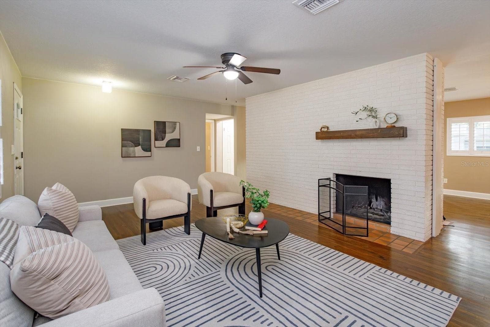15 x 13 living room with original brick accent wall and double sided wood burning fireplace - 1060 GREGORY DR, MAITLAND