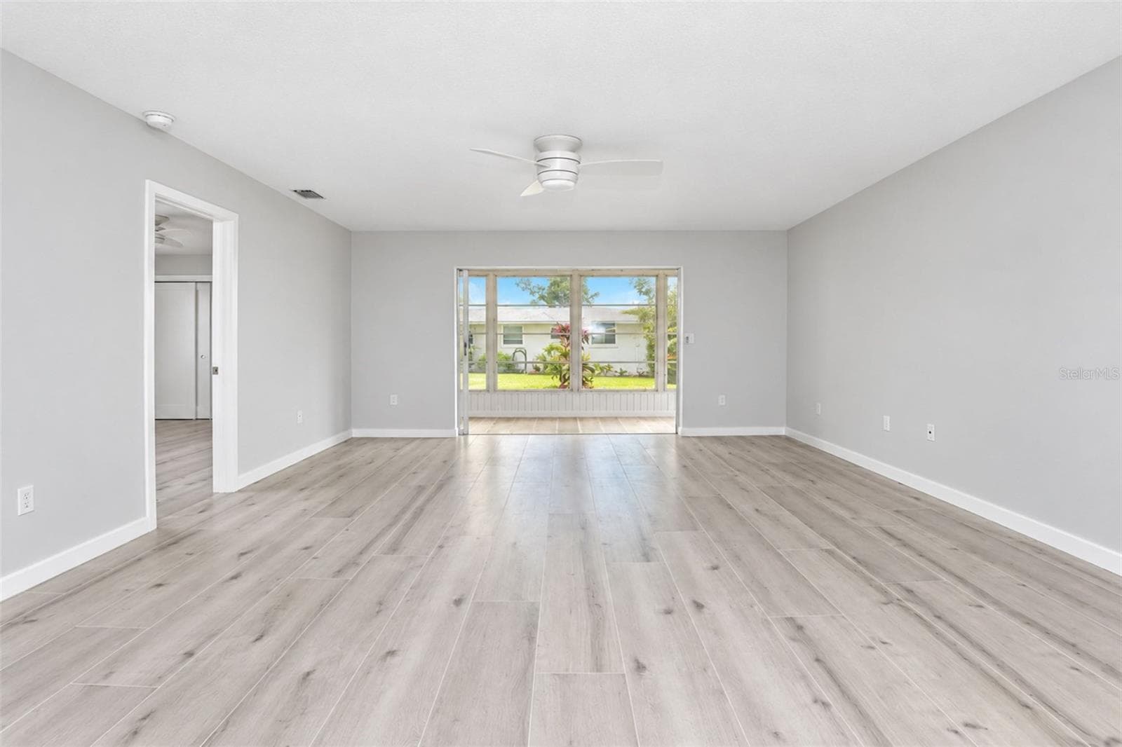 Living room is offered lots of natural light from the 4 season porch - 206 BRIGANTINE WAY #206, NOKOMIS