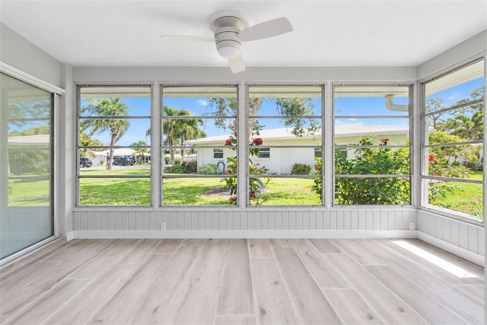 The 4 season room is surrounded in glass windows to provide natural light and beautiful breezes to enjoy Florida's beautiful weather - 206 BRIGANTINE WAY #206, NOKOMIS