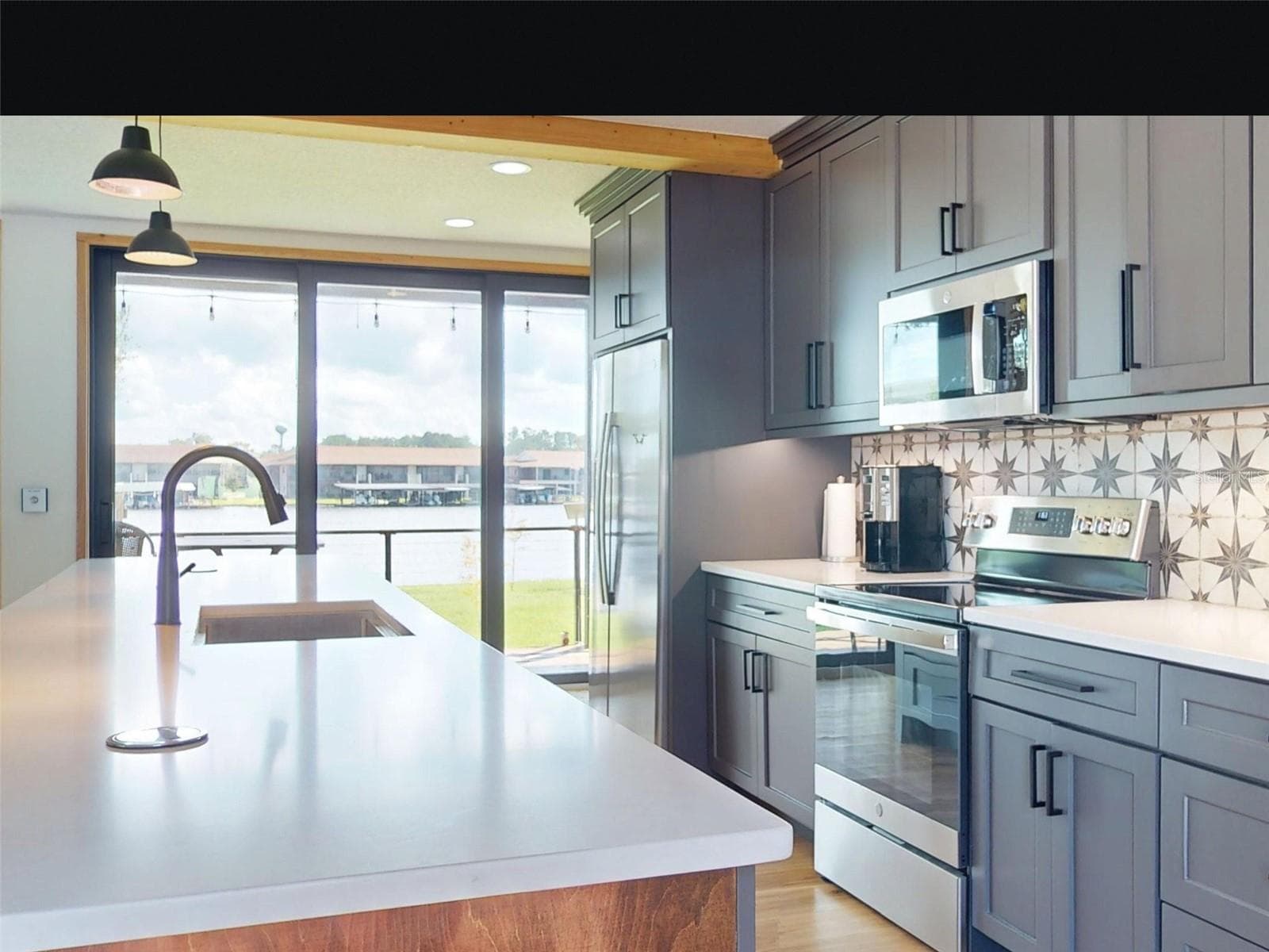 kitchen with snack bar - 56108 SAWGRASS RD, ASTOR