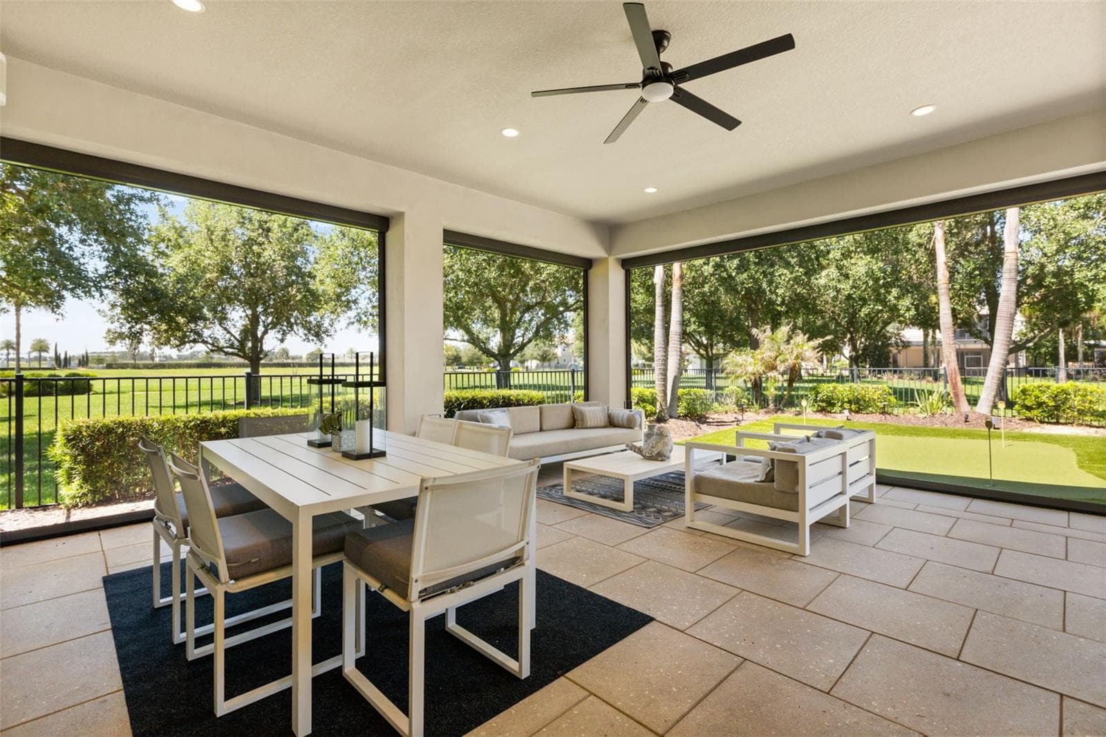 Custom motorized blinds open across all 3 sides of this lanai. A putting green directly facing ahead. Expansive protected green space south side. - 8836 LAKESHORE POINTE DR, WINTER GARDEN