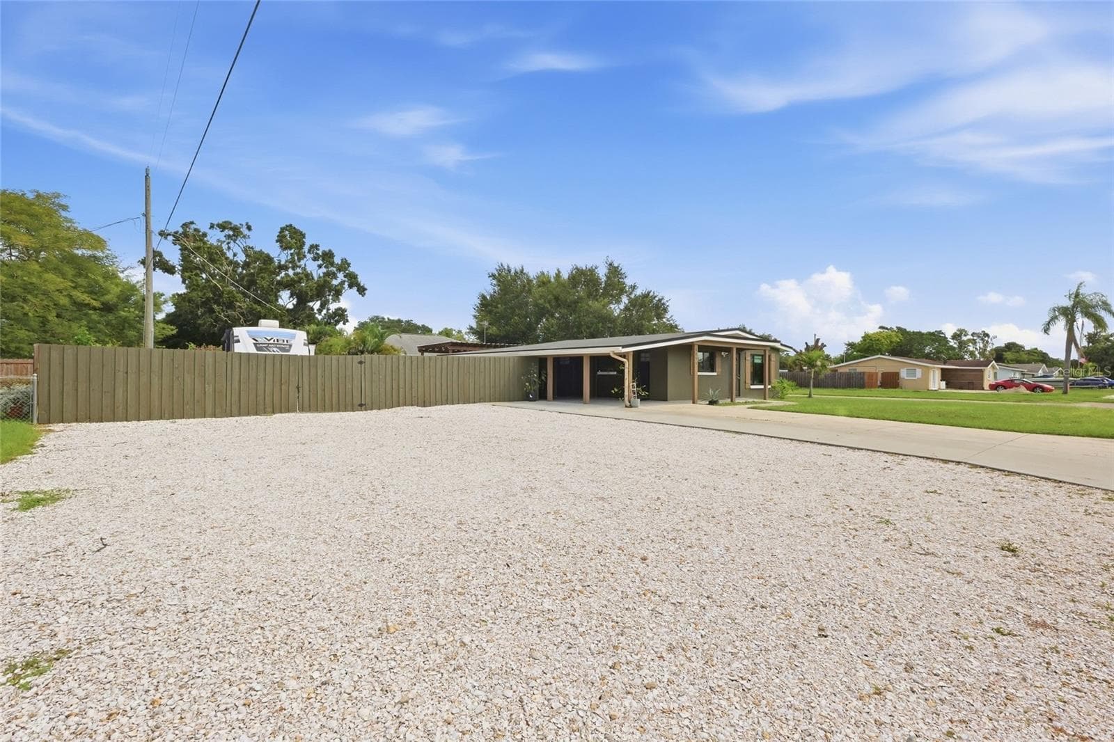 For toy lovers, there is a dedicated shell parking pad with an access gate to the fully fenced in backyard - 5055 LAHAINA DR, SARASOTA