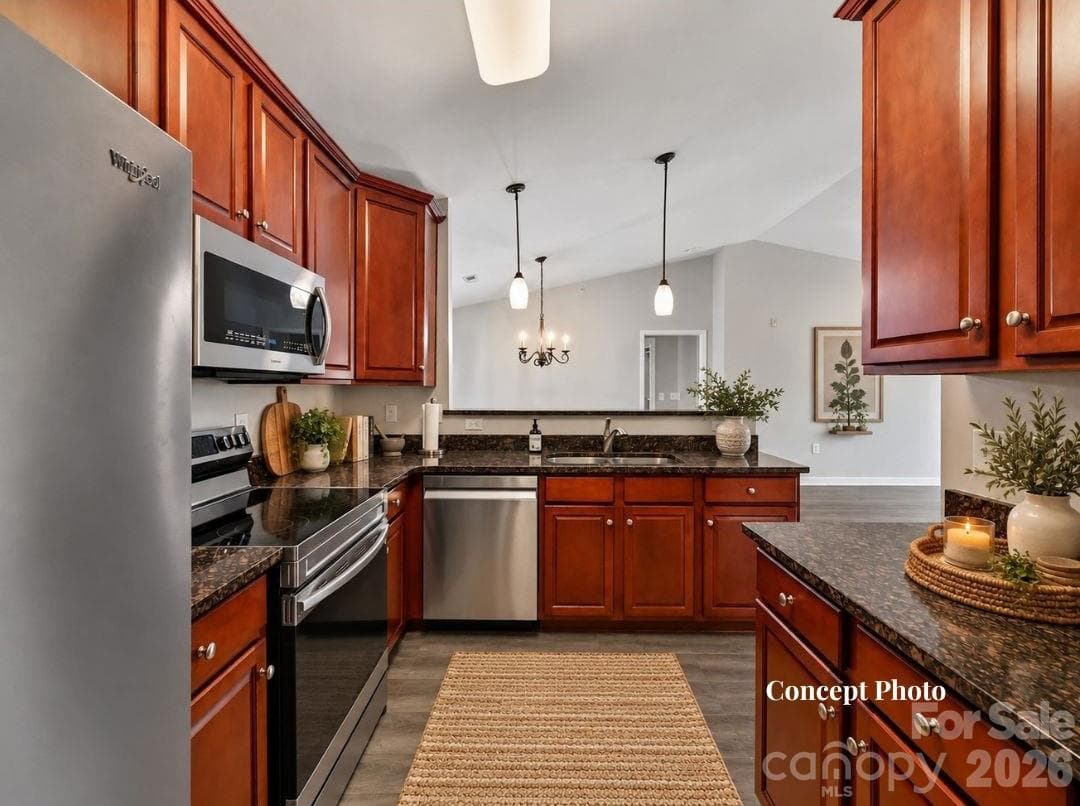Virtually staged Well-appointed kitchen featuring rich wood cabinetry, granite countertops, stainless steel appliances, ample storage, and a convenient breakfast bar overlooking the adjoining living and dining areas. - 9031 Mcdowell Creek Court, Cornelius