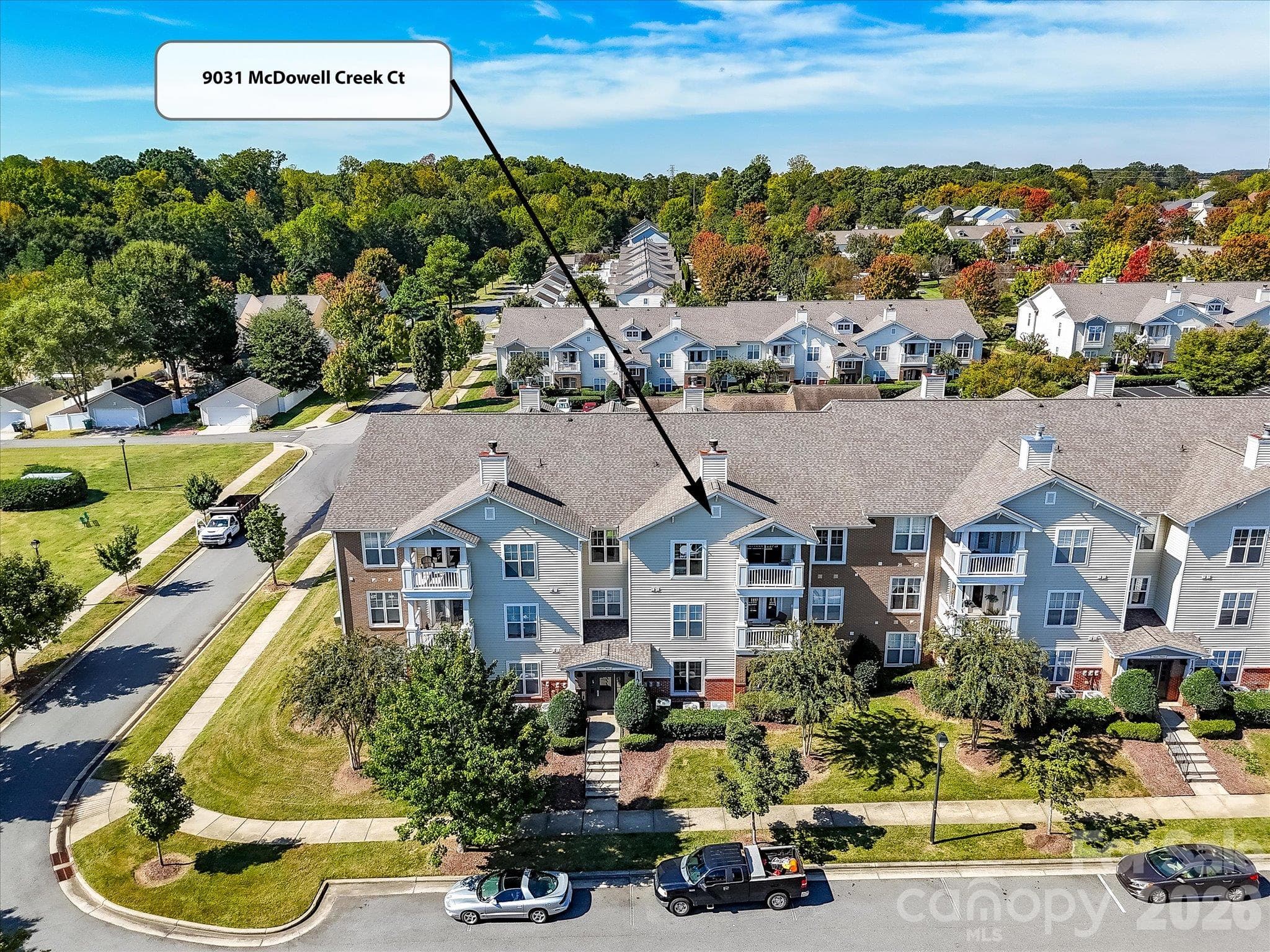 Aerial view highlights the condo’s location within the building, offering an elevated position overlooking the well-maintained community surroundings. - 9031 Mcdowell Creek Court, Cornelius