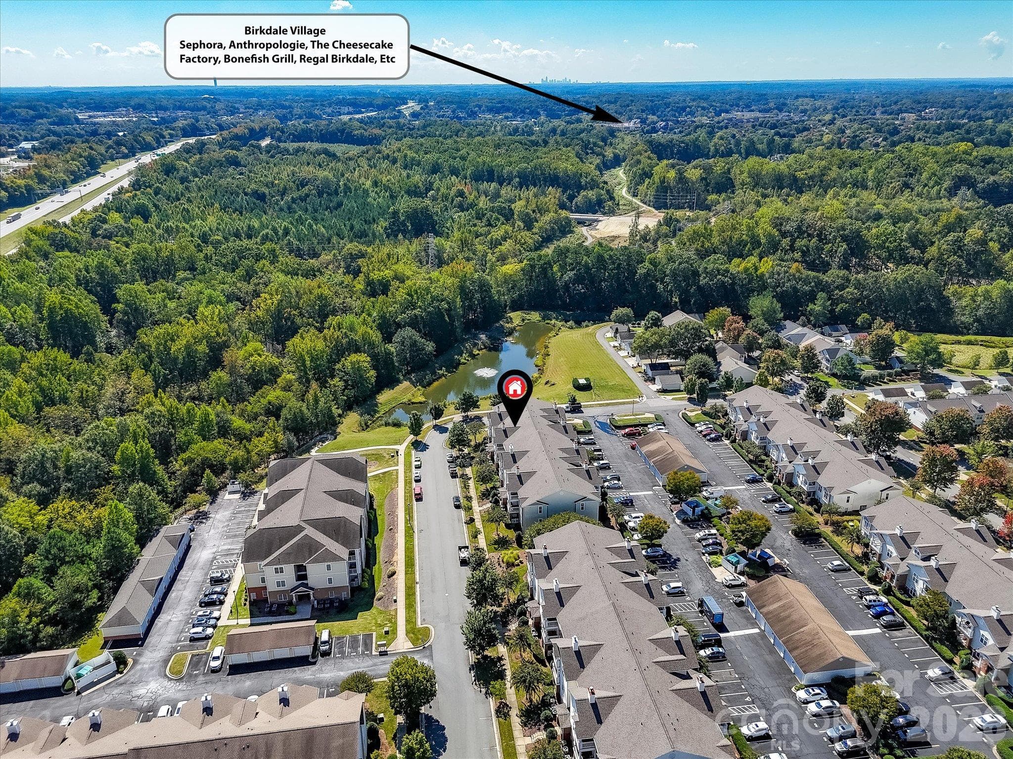 Aerial view highlights the condo’s convenient location near Birkdale Village, offering easy access to popular dining, shopping, breweries, entertainment, and everyday amenities. - 9031 Mcdowell Creek Court, Cornelius