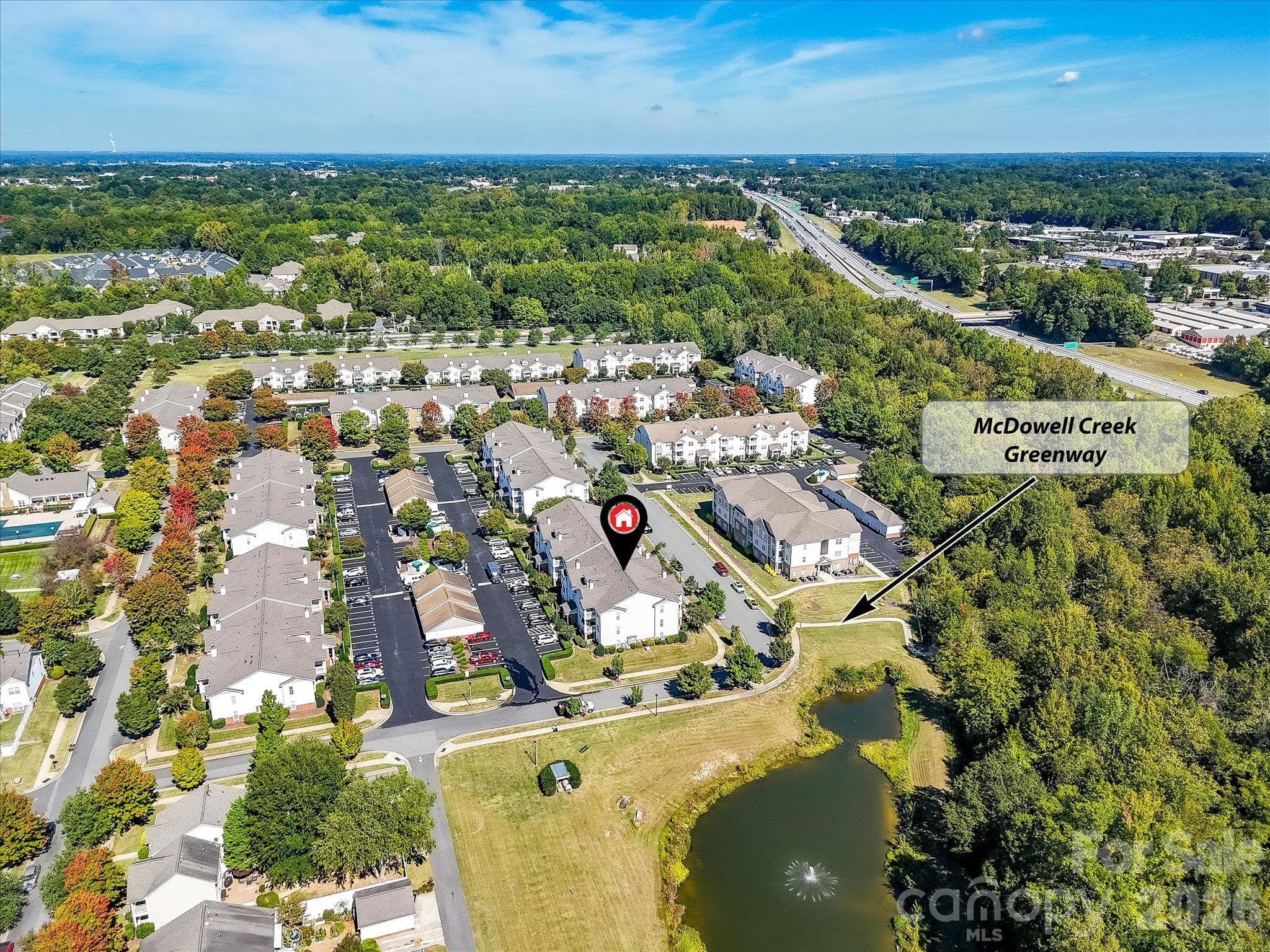 Aerial view highlights the condo’s convenient proximity to McDowell Creek Greenway, offering easy access to nearby walking and recreational trails. - 9031 Mcdowell Creek Court, Cornelius