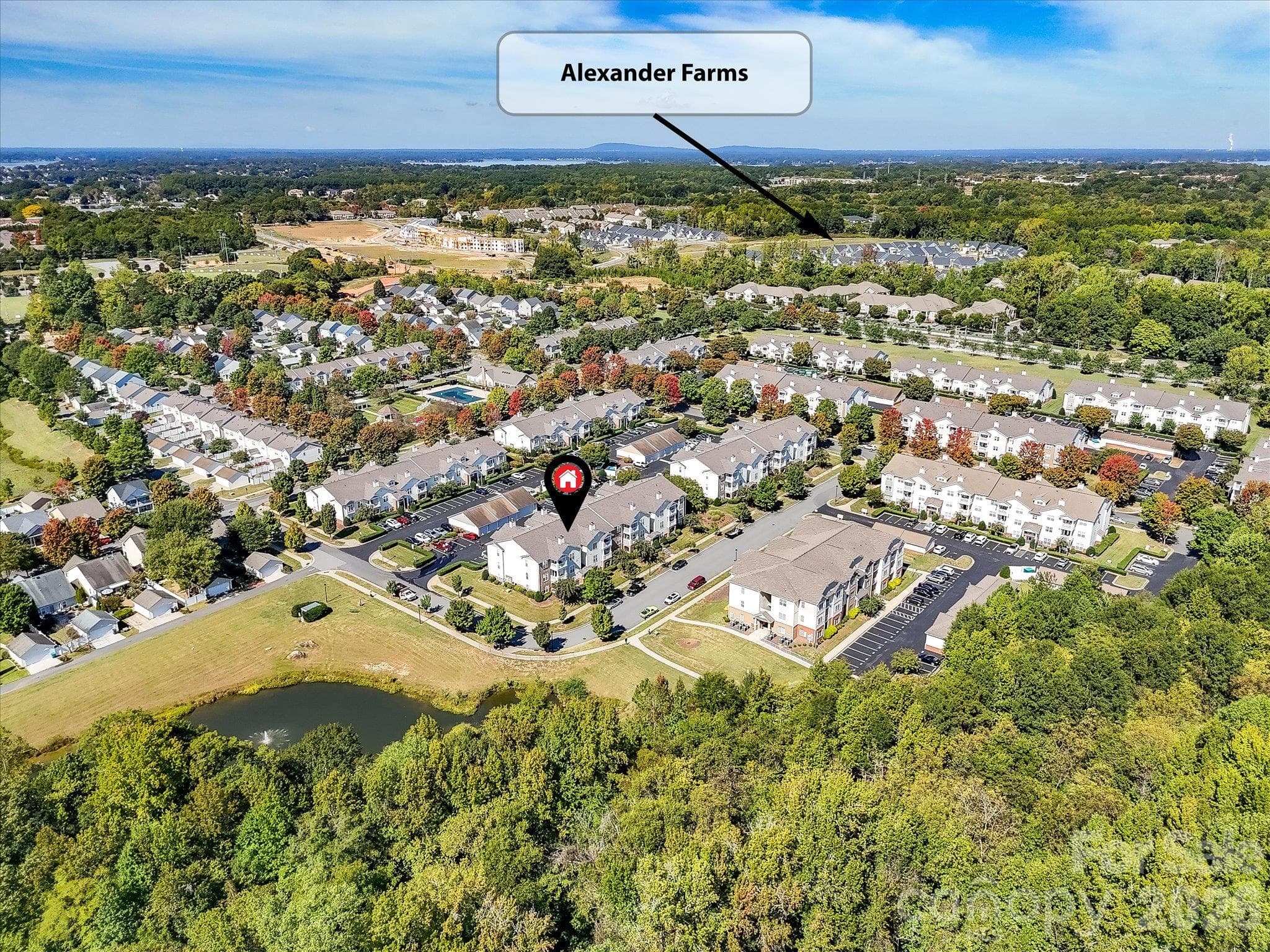 Aerial view highlights the condo’s convenient proximity to Alexander Farms, offering easy access to nearby shopping, dining, and everyday amenities. - 9031 Mcdowell Creek Court, Cornelius