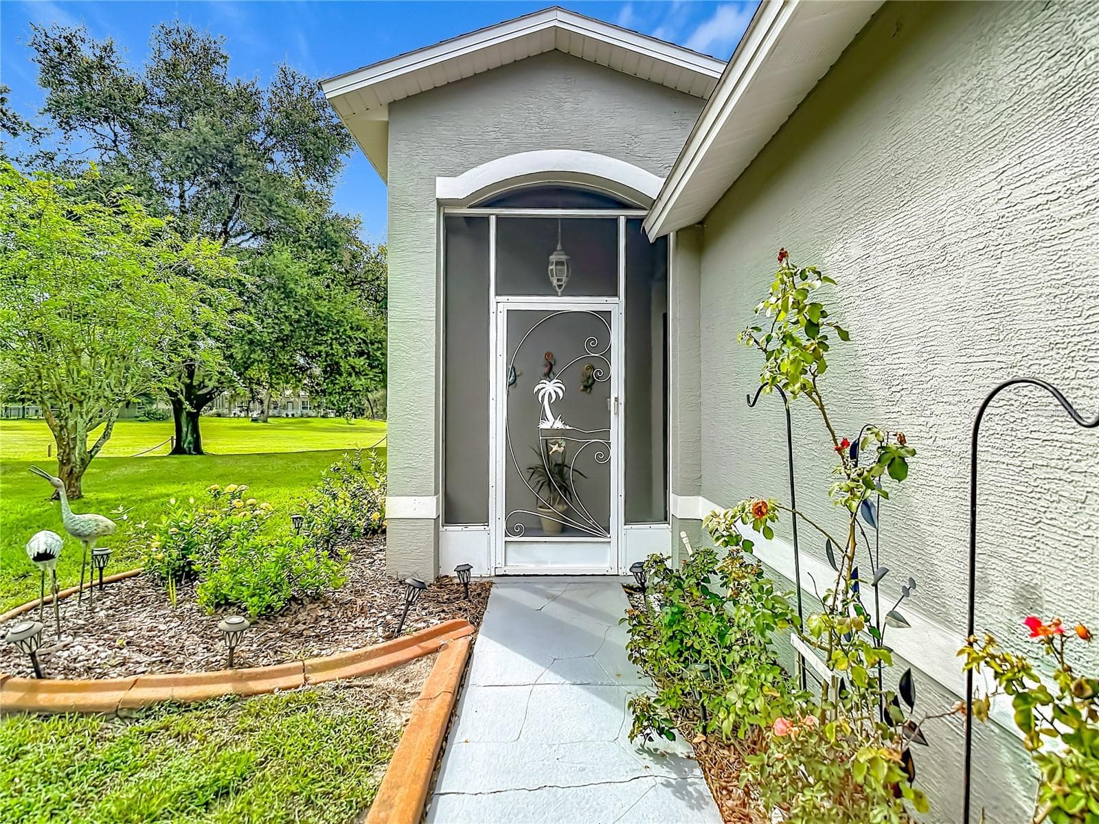 Entry way with cement sidewalk. The exterior painting of the building was done in 2023 - 13428 NORMAN CIR, HUDSON