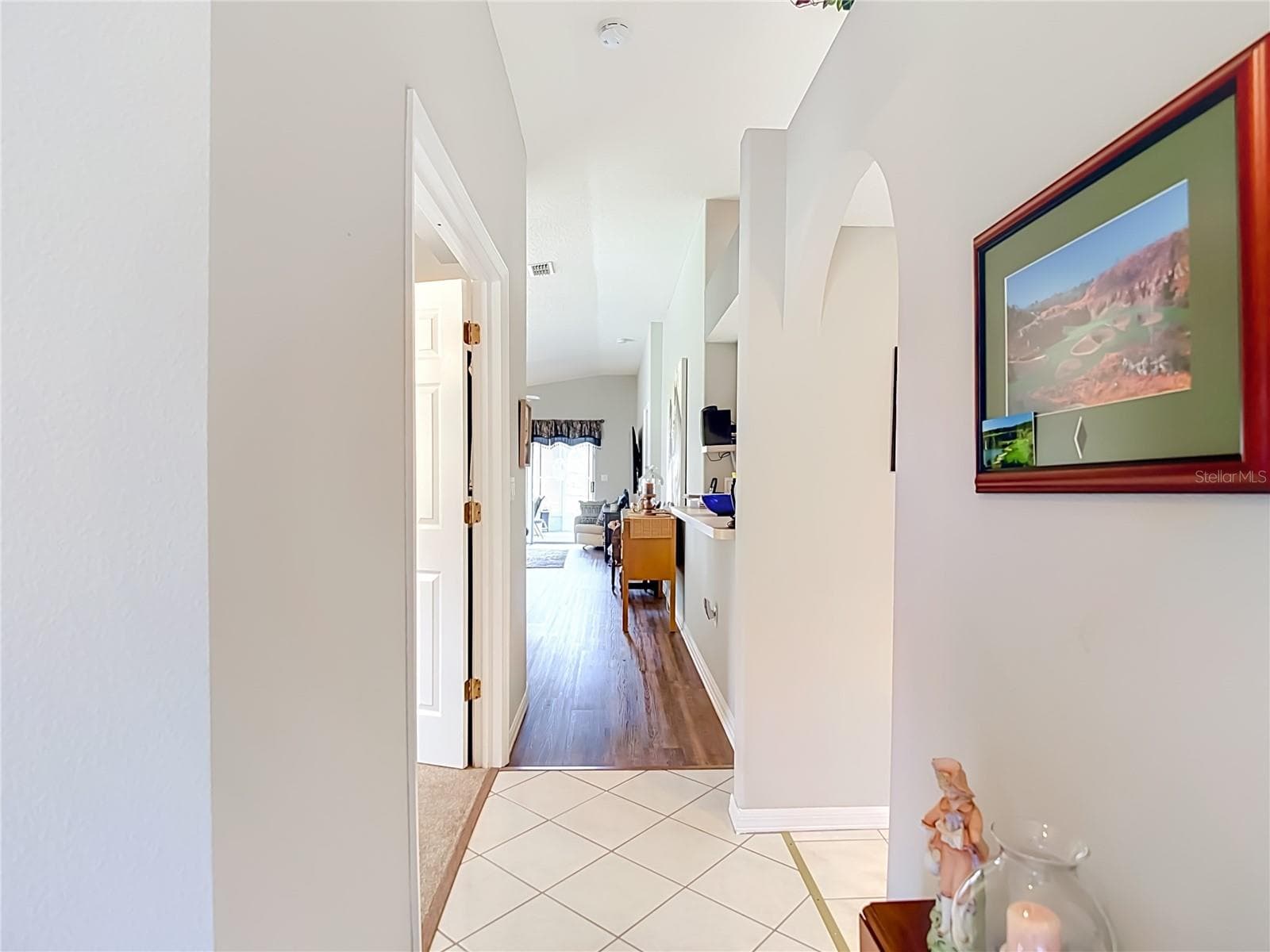 You enter home on a ceramic tile floor. The kitchn is to the right and bedroom 2 is to your left. - 13428 NORMAN CIR, HUDSON