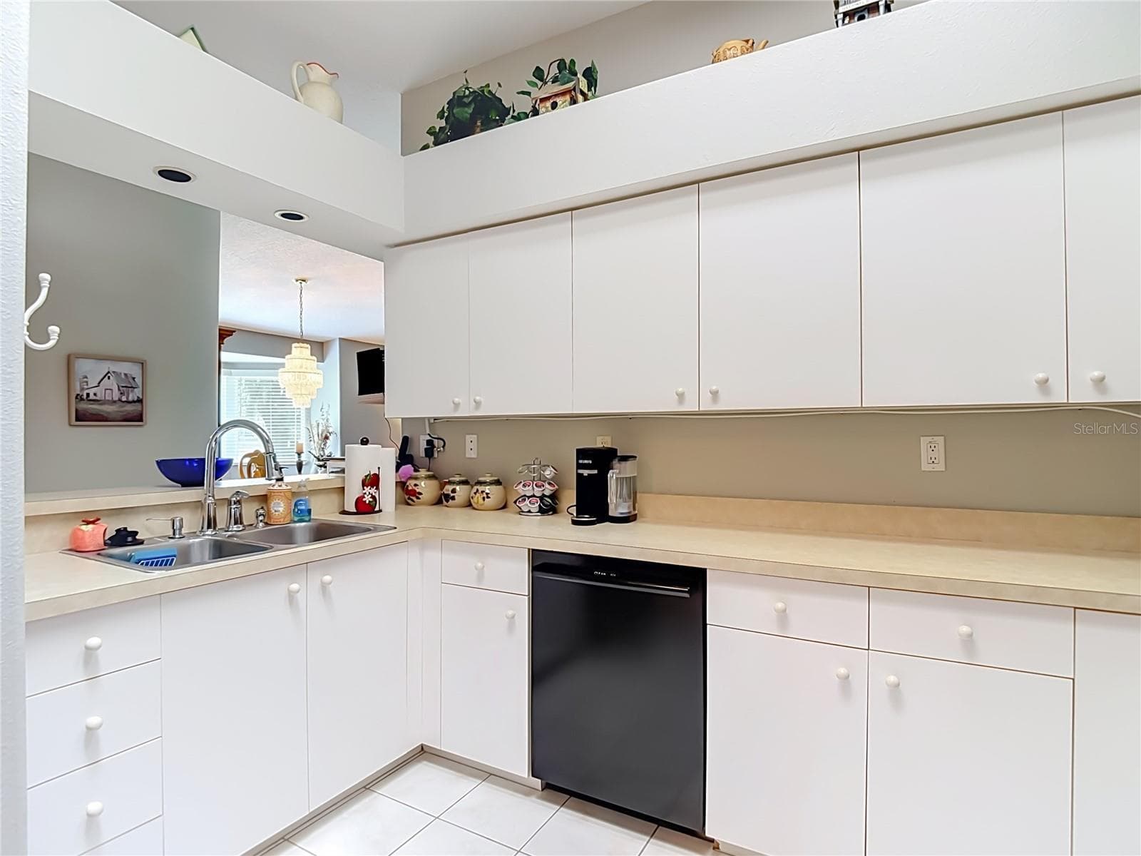 Double sink with newer faucet. There are decorative shelves above the cabinets for your collectibles, plants etc. - 13428 NORMAN CIR, HUDSON