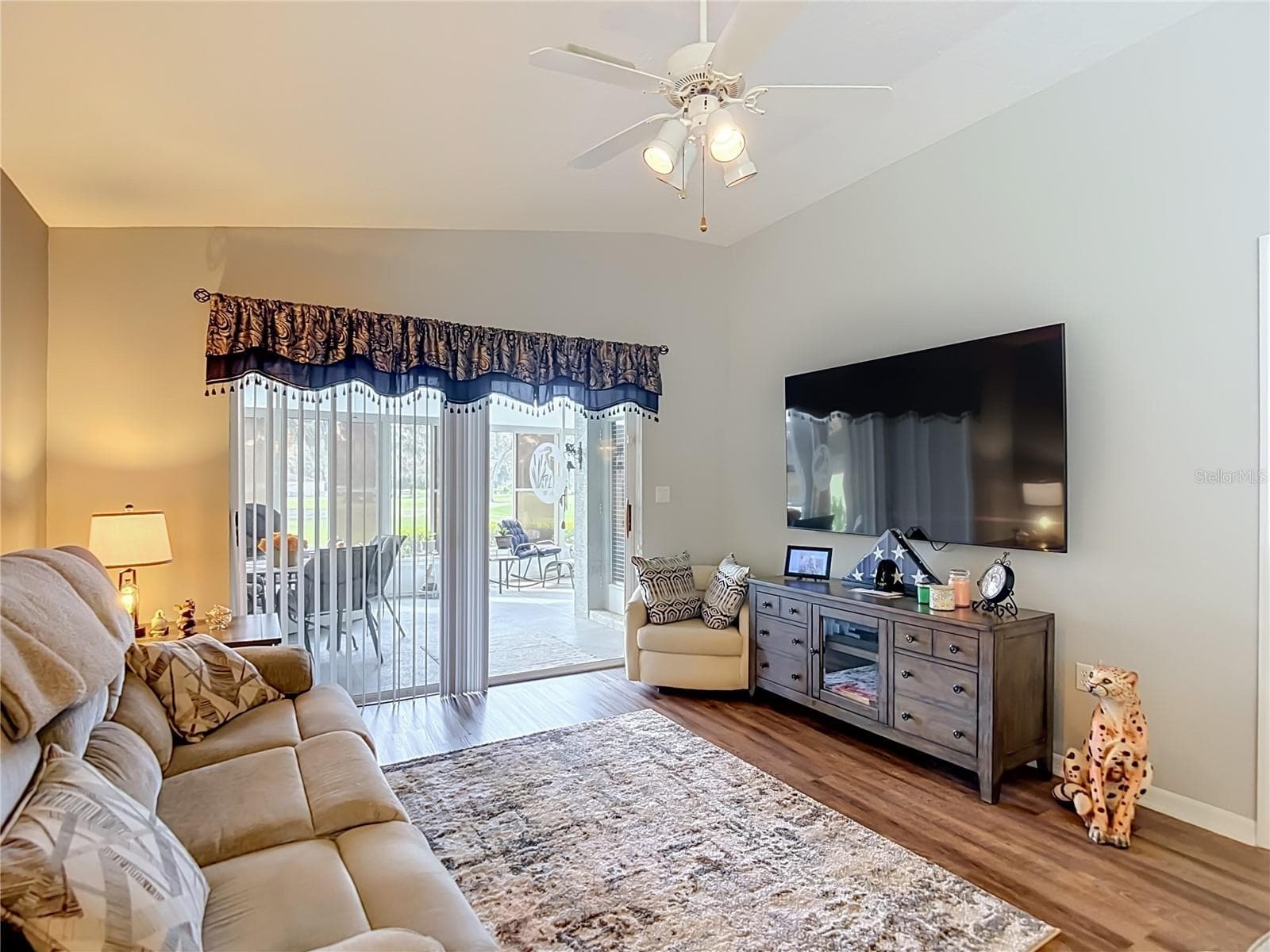 The living room like the rest of the villa has had recent interior painting. The sliding glass doors open onto the lanai / patio. - 13428 NORMAN CIR, HUDSON