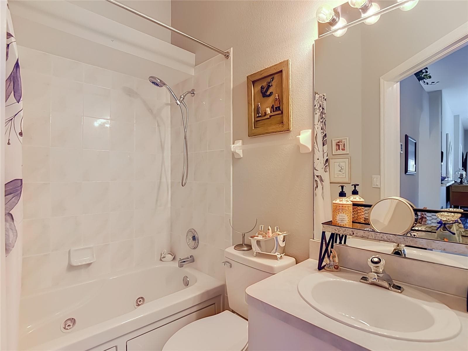 The seconday bathroom is convenient to Bedroom 2 and kitchen. Has combination tub and shower set up. - 13428 NORMAN CIR, HUDSON
