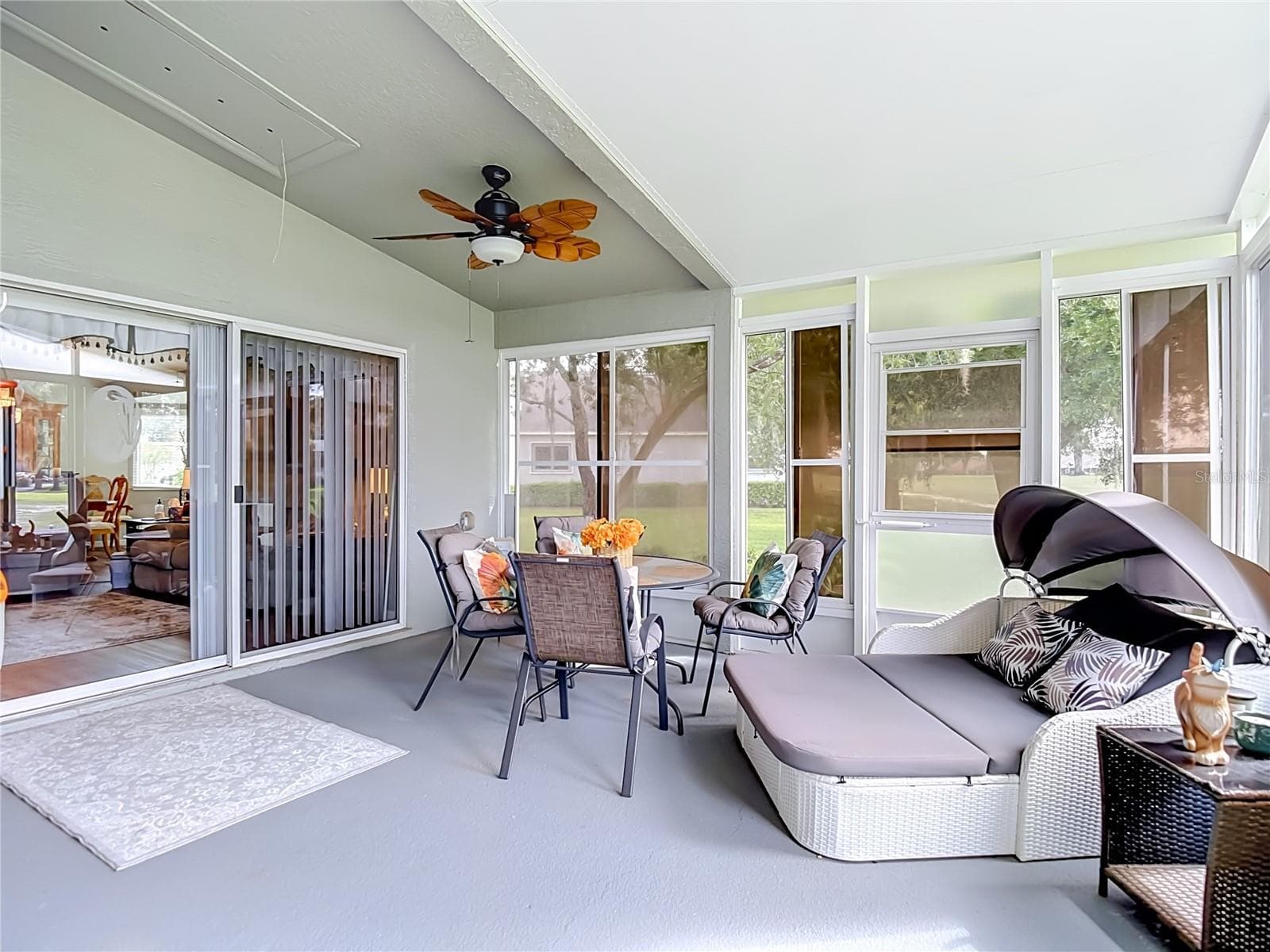 The lanai / patio is huge. Opens from the living room and primary bedroom. Flooring is painted cement. - 13428 NORMAN CIR, HUDSON
