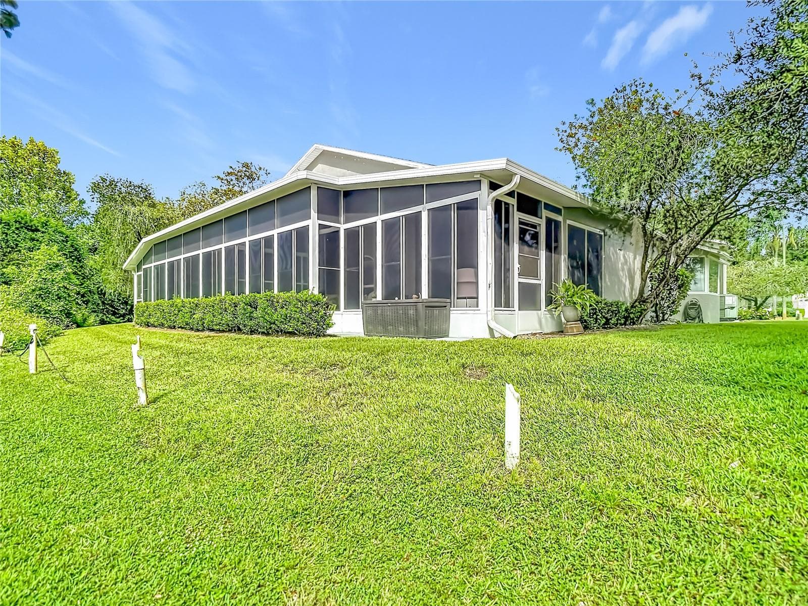 Rear view of the villa. The white stakes are markers for the golf course. - 13428 NORMAN CIR, HUDSON