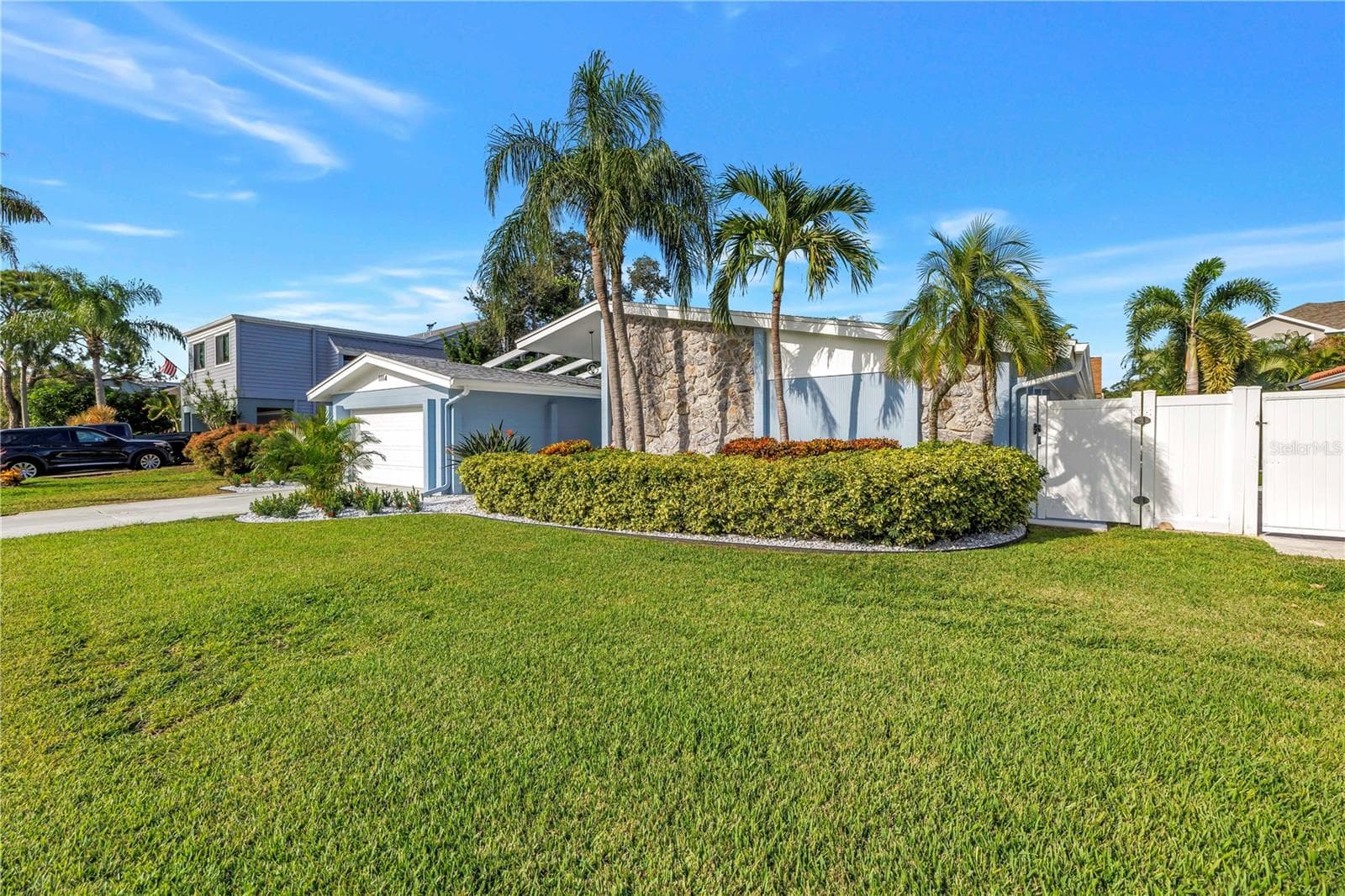 Reclaimed water supplies irrigation for your tropical paradise! Vinyl PVC fence with two access gates on either side. - 1114 2ND AVE S, TIERRA VERDE
