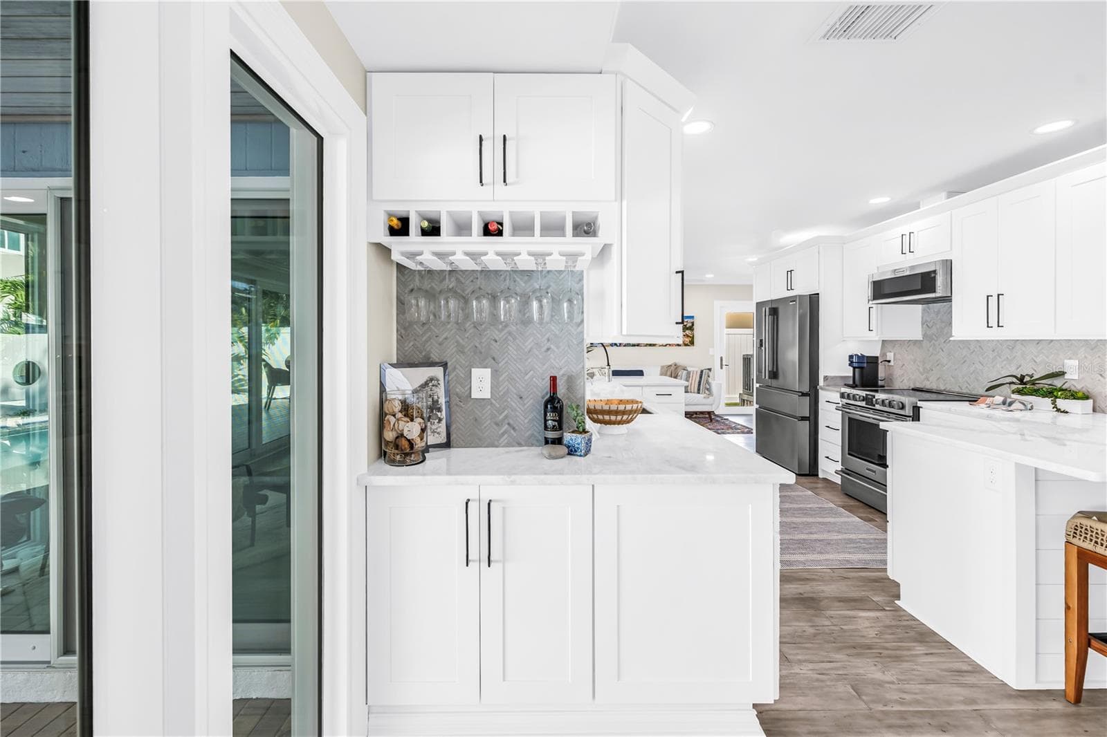 Custom built-in bar area with herringbone tile backsplash. - 1114 2ND AVE S, TIERRA VERDE
