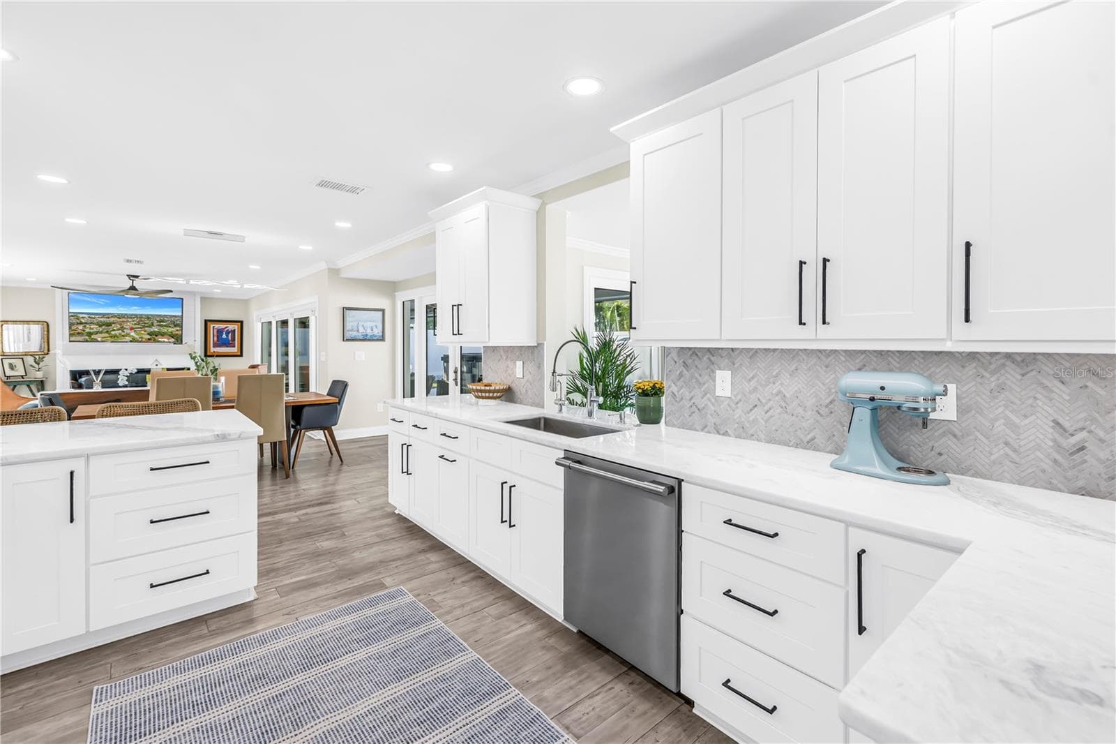 White Shaker cabinetry with upper and lower molding details and under counter lighting. - 1114 2ND AVE S, TIERRA VERDE