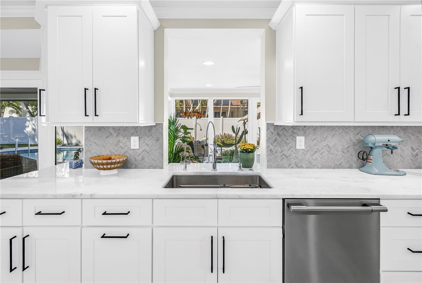 Extra long stainless steel sink with drying shelf hosts instant hot water and filtered cold water. (Pass through to Solarium/ Florida Room) - 1114 2ND AVE S, TIERRA VERDE
