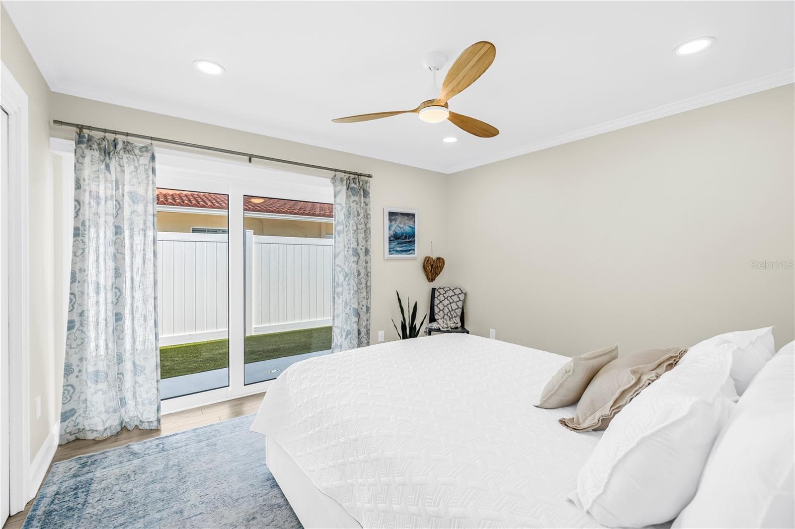 Second bedroom patio to side yard (also has Garrison flood system for sliders). - 1114 2ND AVE S, TIERRA VERDE