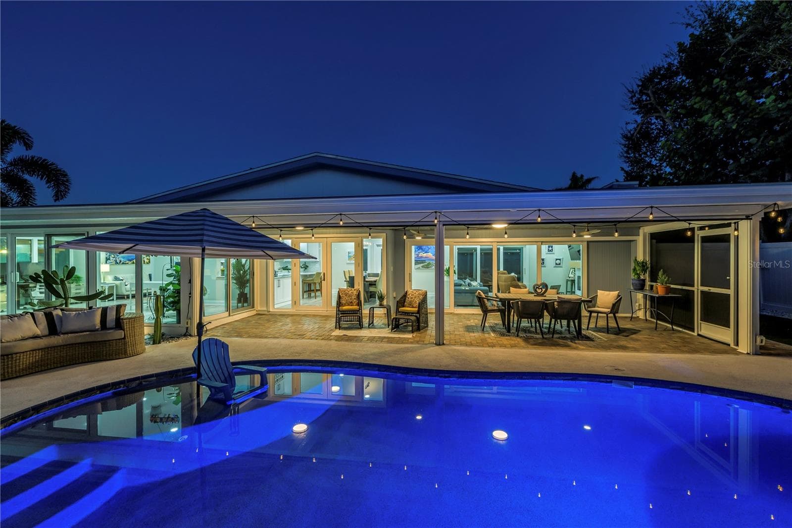 I love the glow of the Edison Lights that reflect in the pool. - 1114 2ND AVE S, TIERRA VERDE