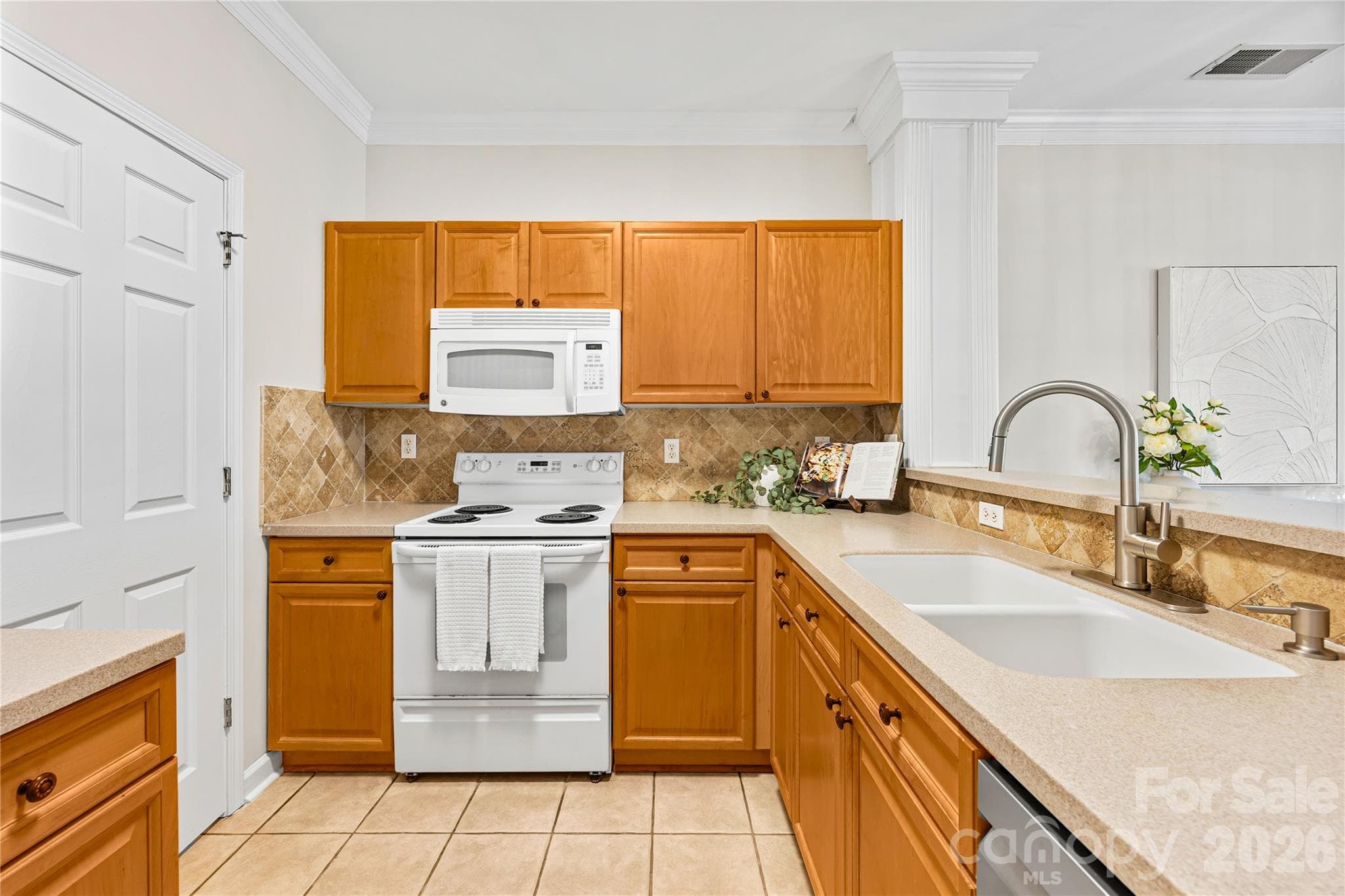 Large kitchen area with amply counter space and bar space for entertaining. All appliances convey. - 915 Northeast Drive, Davidson