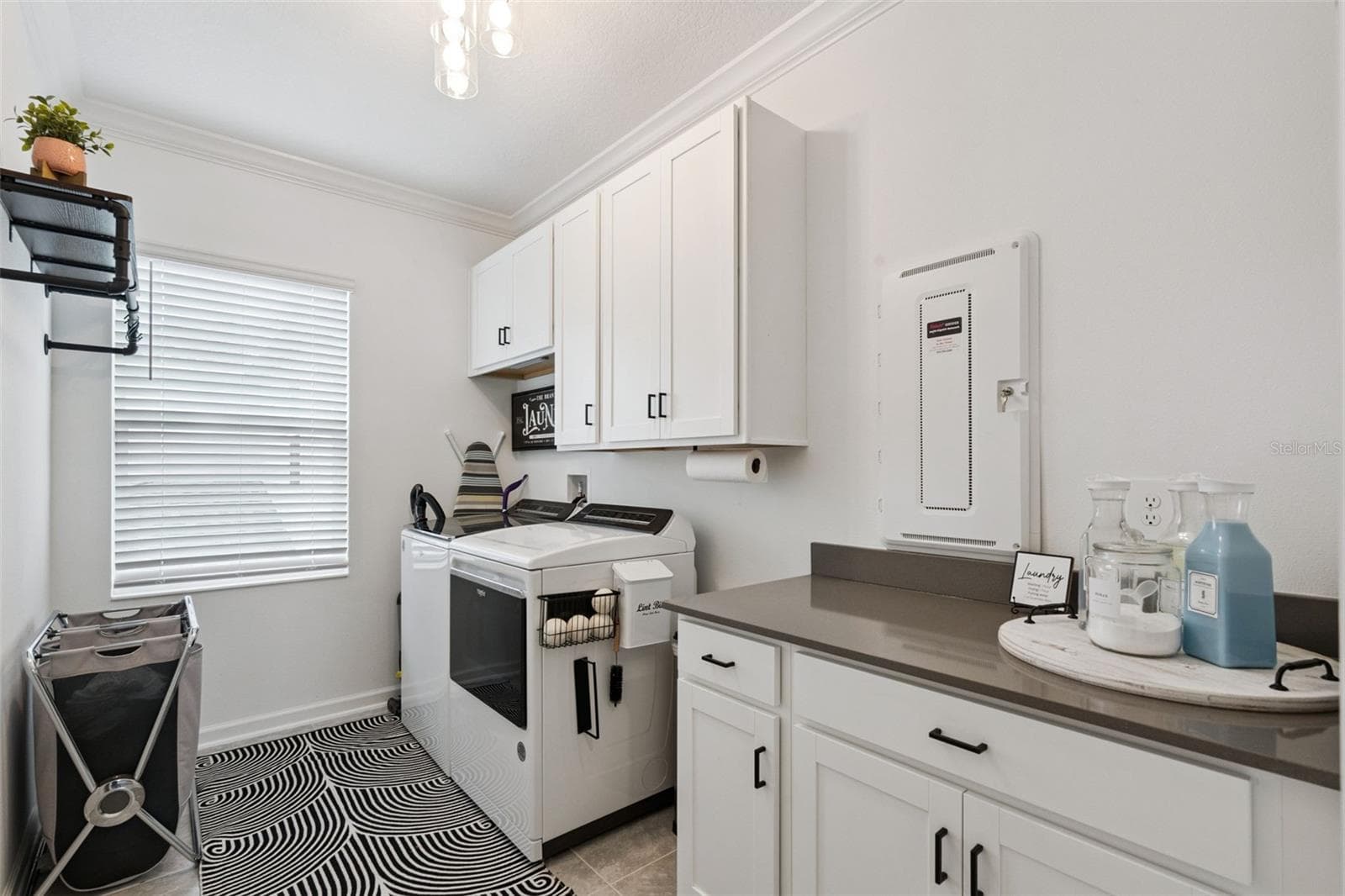 2nd floor oversized laundry room adjacent to owner's suite with stone counter top and plenty of cabinet space - 6175 SHAVASANA RD RD, CLERMONT