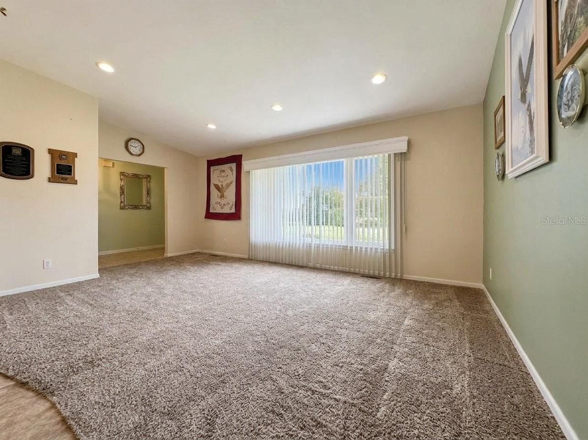 Living Room | Bright front living room showcasing the home's comfortable layout and abundant natural light. - 23088 GRAY AVE, PORT CHARLOTTE