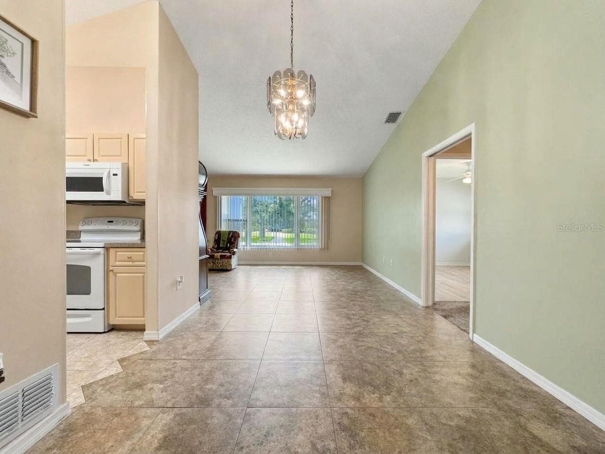 1. Kitchen | Functional kitchen featuring generous cabinetry, countertop workspace, and a large center island. - 23088 GRAY AVE, PORT CHARLOTTE