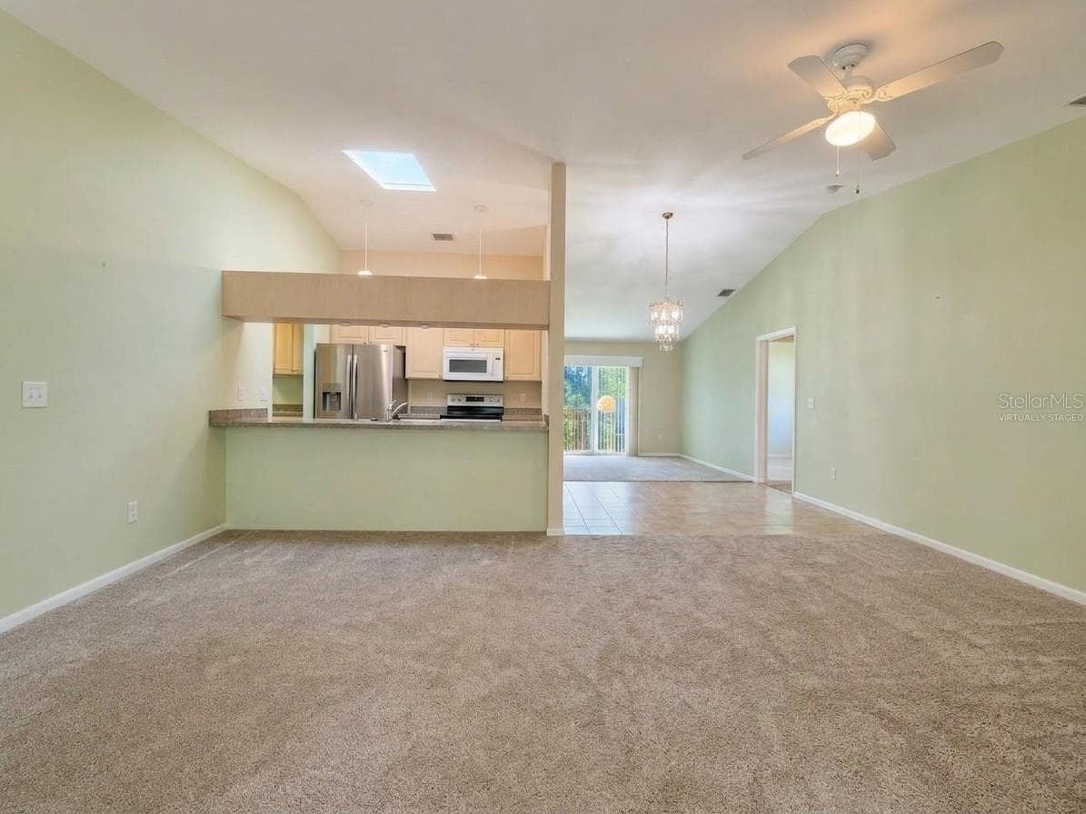 Family Room | Virtually Staged | Spacious family room located just beyond the kitchen with plenty of natural light. Photo has been virtually staged. - 23088 GRAY AVE, PORT CHARLOTTE