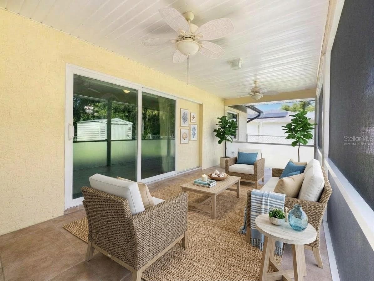 Screened Lanai | Virtually Staged | Spacious screened lanai extends the living space outdoors with plenty of room for relaxing and entertaining. Photo has been virtually staged. - 23088 GRAY AVE, PORT CHARLOTTE